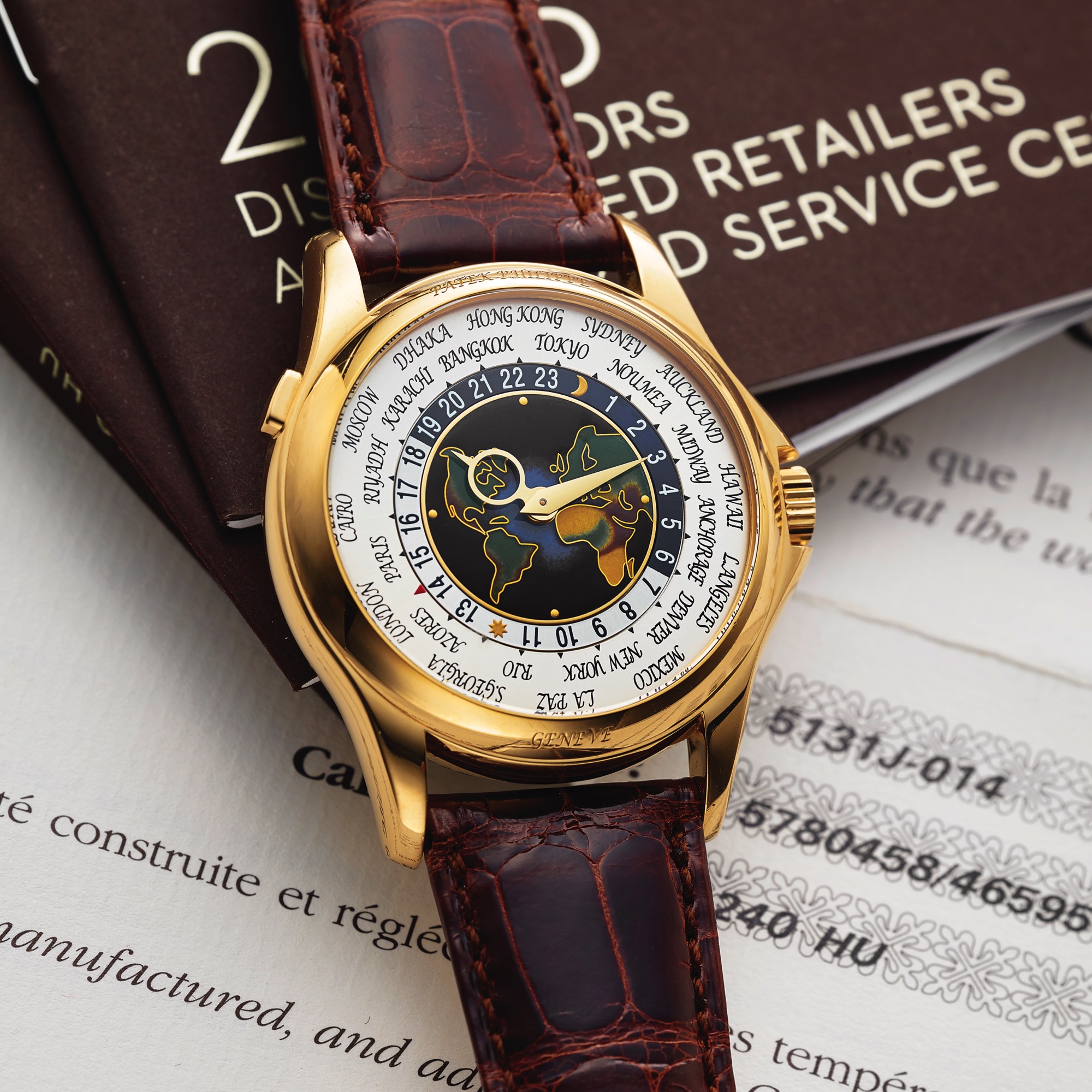 PATEK PHILIPPE REF. 5131 ENAMEL DIAL YELLOW GOLD 
Patek Philippe, Genève, World Time, Ref. 5131J-014. No. 5780458, case No. 4659579. Sold on 1st October 2014. 
Very fine and rare, self-winding, water-resistant, 18K yellow gold wristwatch with worldtime system, cloisonné 
enamel dial and an 18K yellow gold Patek Philippe deployant clasp. Accompanied by fitted box, Certificate of 
Origin, booklets, distributors and Collectors library booklets and instruction booklet.