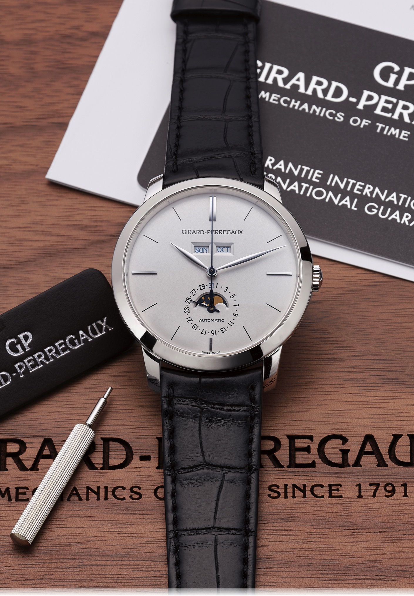 GIRARD-PERREGAUX REF. 49535 1966 
LIMITED EDITION TRIPLE CALENDAR PLATINUM 
Girard-Perregaux, '' 1966'', No. 92/100, Ref. 49535. 
Made in a limited edition of 100 pieces in 2011. 
Very fine and Very rare, center-seconds, self-winding, 
platinum wristwatch with triple calendar, moon phases and 
an platinum Girard Perregaux buckle. Accompanied by the 
original fitted box, guarantee card, certificate, hang-tag, 
instruction manual and setting pin.
