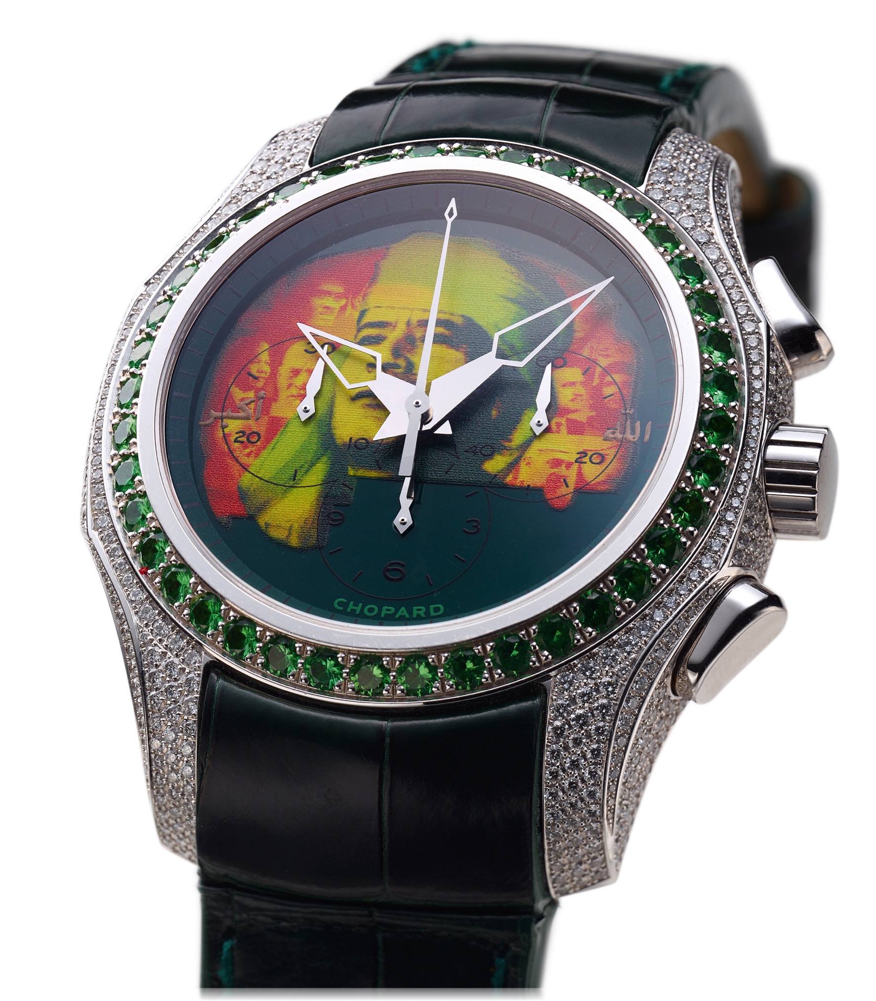 CHOPARD POSSIBLY UNIQUE EMERALD
DIAMOND AND WHITE GOLD
Chopard, Genève, "Libya 1.9.2009", case No. 1528258. Made to mark the 40th anniversary 
of the Libyan Revolution in 2009. 
Fine and rare, self-winding, 18K white gold, emerald and diamond set wristwatch with 
oval button chronograph, registers, printing Muammar Qaddafi motif dial date and 18K 
white gold and diamond set Chopard buckle.