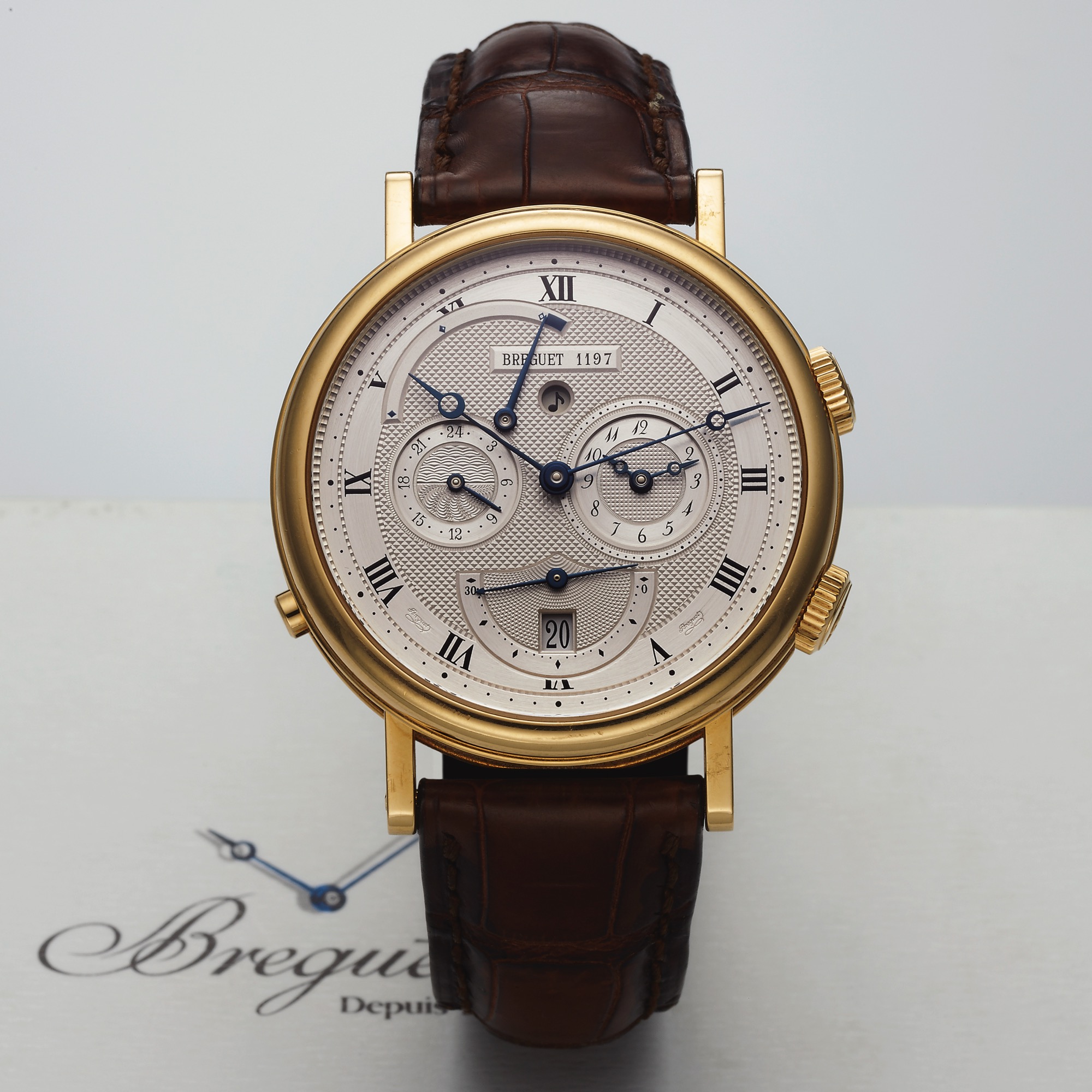 BREGUET REF. 5707 LE REVEIL DU TSAR 
ALARM YELLOW GOLD 
Breguet, Classique Le Réveil du Tsar, No. 1197, 
Ref. 5707. Made circa 2000. 
Very fine, two time zone, self-winding, water-
resistant, 18K yellow gold wristwatch with alarm, 
alarm power reserve/ function indicators and 
an 18K yellow gold Breguet deployant clasp. 
Accompanied by the Certificate of Origin, warranty 
and instruction booklet.