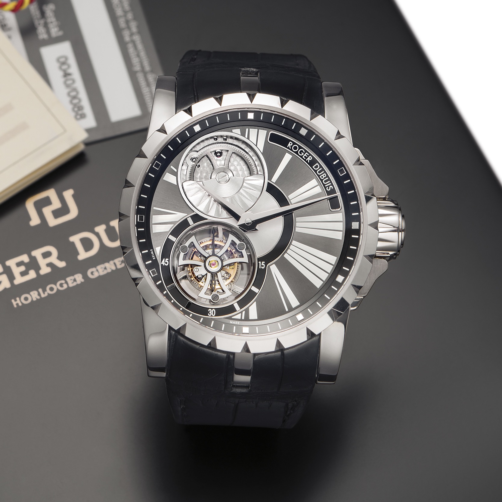 ROGER DUBUIS EXCALIBUR FLYING TOURBILLON WHITE GOLD 
Roger Dubuis, Horloger Genevois, "Excalibur, Flying Tourbillon" No. 40/88, movement No. 06, 
Ref. DBEX0285. Made in a limited edition of 88 pieces circa 2012. 
Very fine and rare, large, water-resistant, self-winding 18k white gold wristwatch with visible 
one-minute flying tourbillon regulator and an 18k white gold Roger Dubuis deployant clasp. 
Accompanied by the original box, warranty card, COSC and CD-Rom.