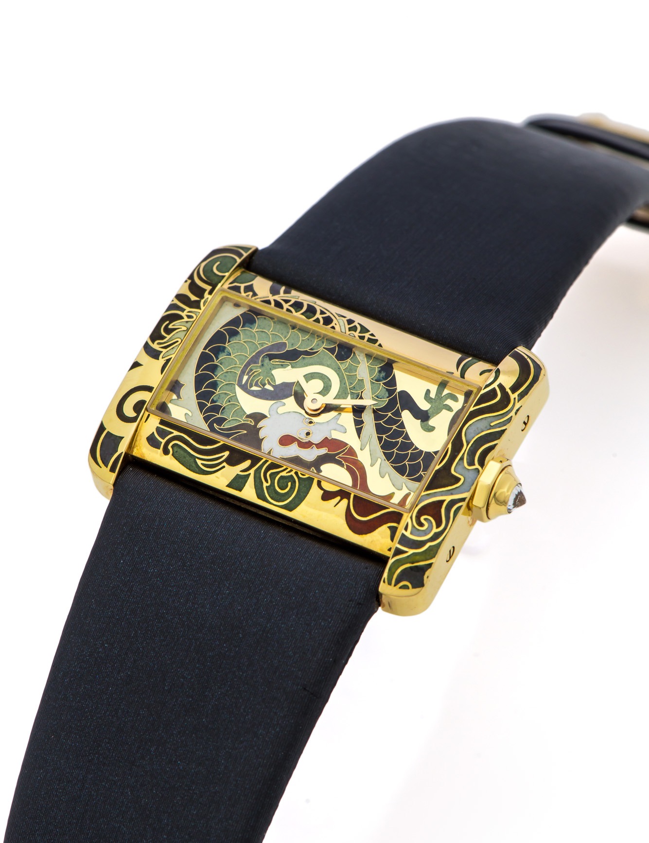 CARTIER TANK DIVAN REF. 2601 YELLOW GOLD CLOISONNE LIMITED EDITION
Cartier, Tank Divan, quartz, Ref. 2601. Made in a limited edition of 20 pieces in 2000s.
Fine and extremely rare, horizontal rectangular and curved, water-resistant, 18K yellow gold quartz wristwatch with dragon cloisonné enamel and 
an 18K yellow gold Cartier buckle.