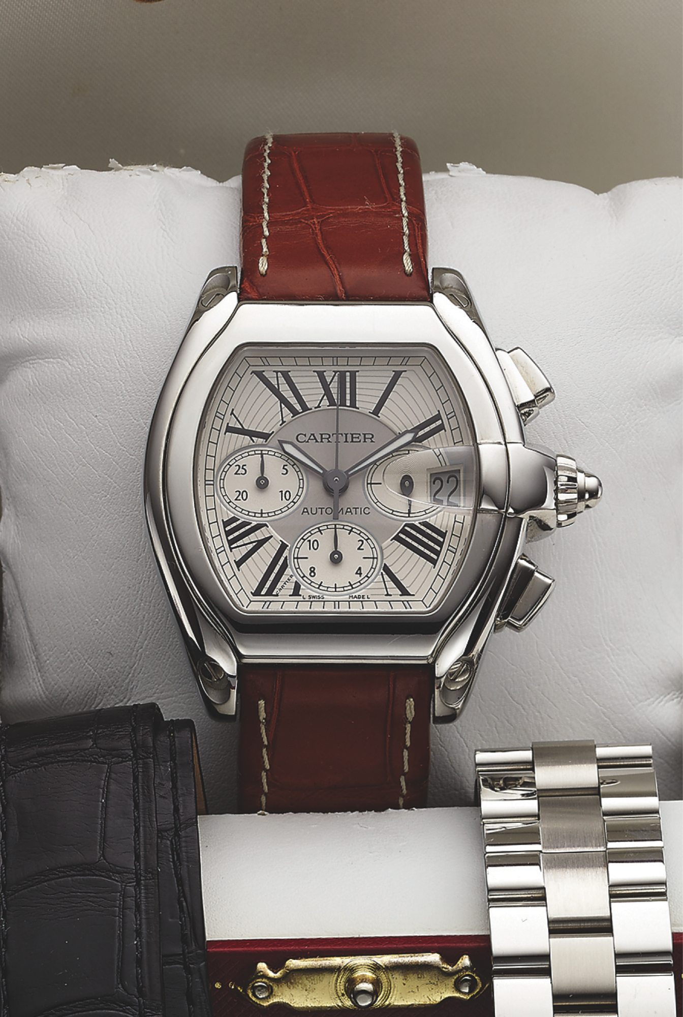 CARTIER REF. 2618 ROADSTER CHRONOGRAPH STEEL
Cartier, ?Roadster Chronograph, Automatic,? case No. 703317CE,
Ref. 2618. Made in 2010, sold March 1st, 2011.
Fine, tonneau-shaped, curved, self-winding, water-resistant,
stainless steel wristwatch with square button chronograph,
registers, date, tachometer and a stainless steel Cartier
deployant clasp. Accompanied by the original fitted box,
certificate, instruction manual, 2 extra Cartier straps and a ?quick
change? stainless steel Cartier l