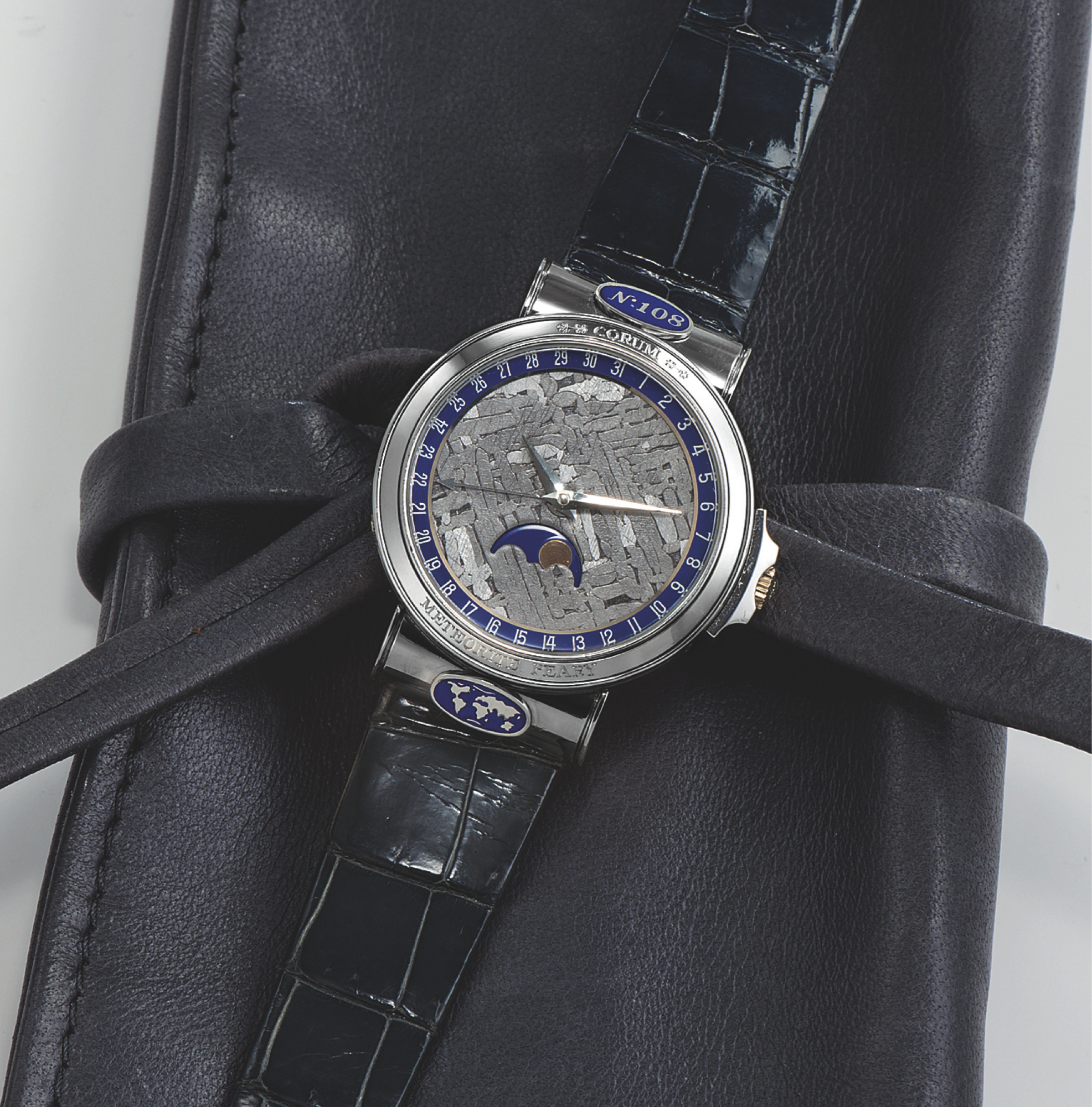 CORUM METEORITE PEARY PLATINUM
Corum, ?Meteorite Peary?, No. 108, case No. 460337, Ref.
71.450.70. Made in the 1990?s.
Very fine and rare, self-winding, water-resistant, platinum
wristwatch with meteorite dial, date, moon phases and an
stainless steel Corum buckle. Accompanied by a box