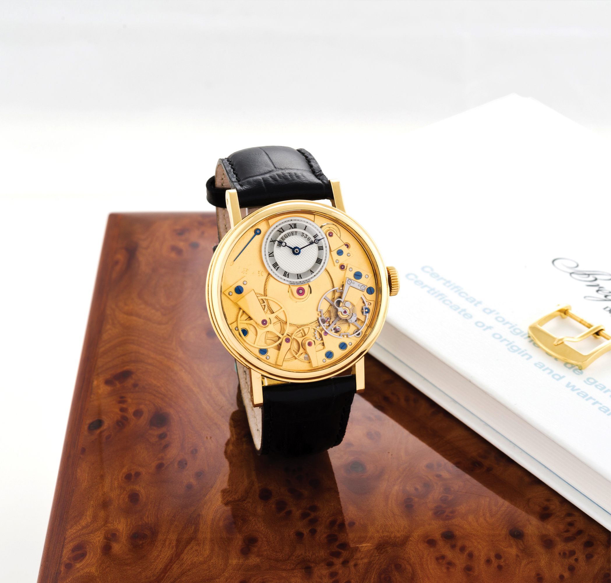 BREGUET REF. 7027, CLASSIQUE "LA TRADITION BREGUET" 
Breguet, "La Tradition", No. 3362, Ref. 7027. Sold on November 26th, 2005. 
Very fine, water-resistant, 18K yellow gold wristwatch with visible 
"Souscription" style caliber, double power reserve indication and an 18K 
yellow gold Breguet buckle. Accompanied by a Breguet fitted box, user's 
manual and Certificate of Origin and Wempe warranty card.
