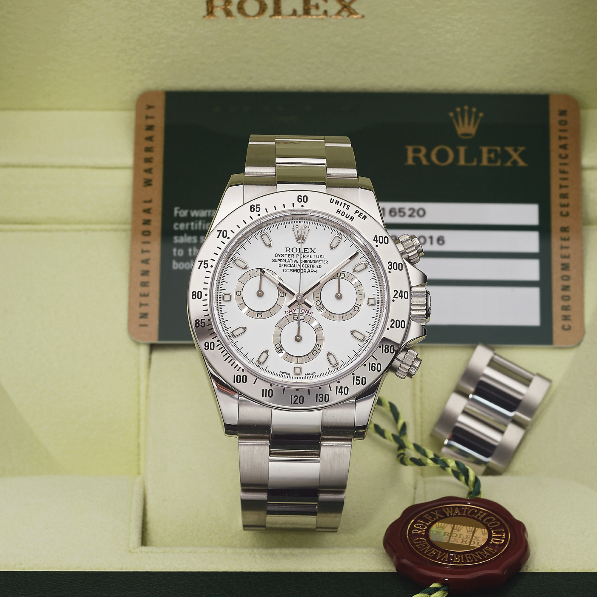 ROLEX REF 116520 DAYTONA STEEL 
Rolex, "Oyster Perpetual, Superlative Chronometer, Officially 
Certified, Cosmograph Daytona" case No. 7C918016, Ref. 
116520, sold April 27th, 2013. 
Very fine, self-winding, water-resistant, stainless steel 
wristwatch with round button chronograph, registers, 
tachometer and a stainless steel Rolex Oysterlock bracelet 
with deployant clasp. Accompanied by the original fitted 
box, instruction booklet, guarantee (now void), hang tags 
and 2 extra links.