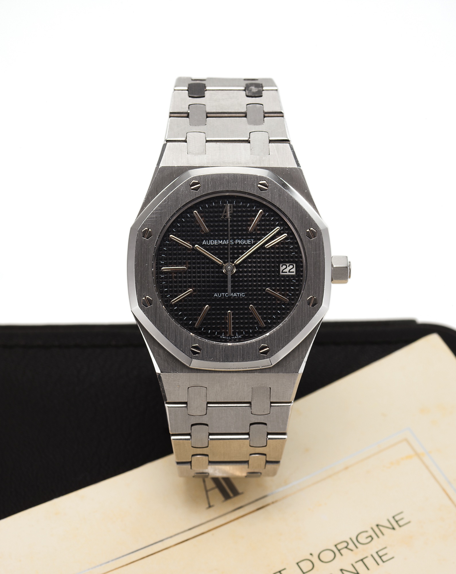 AUDEMARS PIGUET REF. 14332ST. ROYAL OAK STEEL 
Audemars Piguet, "Royal Oak Automatic," No. 039, Ref. 14332ST. 
Made circa 1980s. 
Very fine, octagonal, tonneau-shaped, selfwinding, water 
resistant, stainless steel wristwatch with date and a stainless 
steel Audemars Piguet bracelet with deployant clasp. 
Accompanied by a fitted box and guarantee.