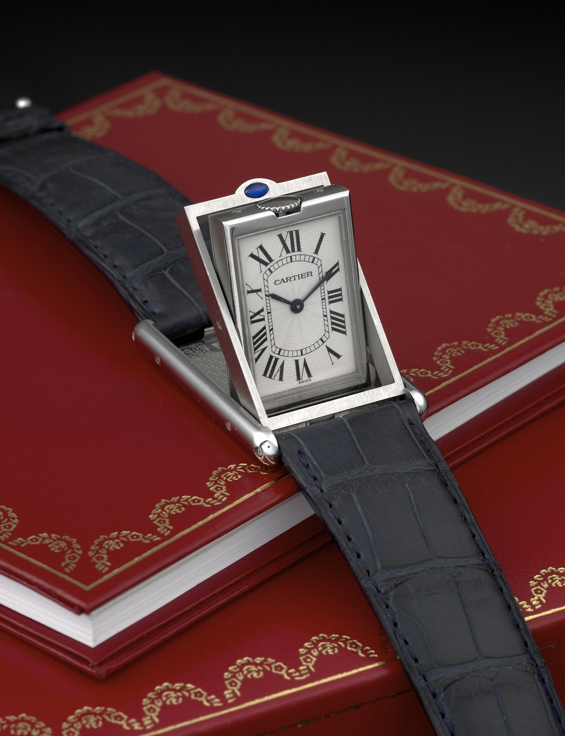 CARTIER REF. 2390 TANK BASCULANTE
MECHANICAL STEEL
Cartier, Paris, Reversible Basculante, case No. 292606 MG,
Ref. 2390. Made in 2002.
Fine and unusual, rectangular, stainless steel wristwatch with
cabriolet pivoting system and a stainless steel Cartier buckle.
Accompanied by the original fitted box.
