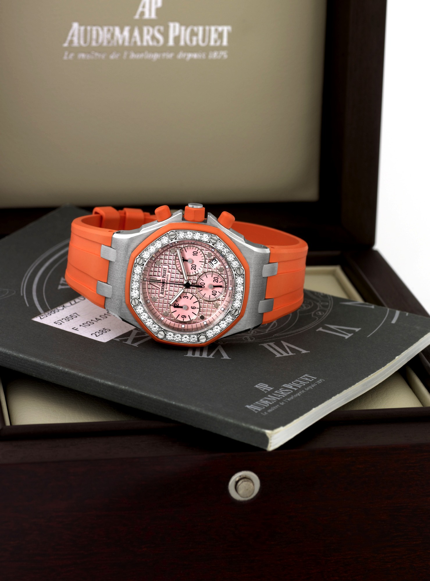 AUDEMARS PIGUET 18K ROYAL OAK OFFSHORE
LADY'S DIAMONDS
Audemars Piguet, ?Royal Oak, Offshore, Automatic?,
No. 196, mouvement No. 573557, case No. F10314,
Ref. 25986CK. Made in 2005.
Fine, tonneau-shaped, octagonal, self-winding, water
resistant, 18K white gold and orange rubber-coated
lady?s wristwatch with diamond-set bezel, round-button
chronograph, registers and date, set and an Audemars Piguet
18K white gold deployant clasp. Accompanied by the original
fitted box and an Audemars Pi