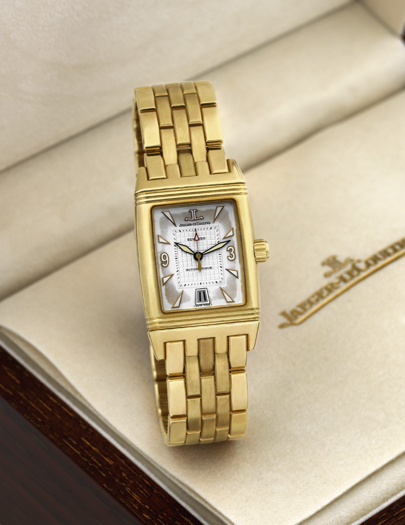 JAEGER LECOULTRE REVERSO GRAN SPORT
YELLOW GOLD
Jaeger-LeCoultre, ?Reverso Gran Sport?, case No. 1907782,
Ref. 290.1.60. Made circa 2000.
Very fine, heavy, rectangular, center seconds, water-resistant,
self-winding, 18K yellow gold reversible wristwatch with
date and an 18K yellow gold Jaeger-LeCoultre link bracelet
with double deployant clasp. Accompanied by fitted box,
guarantee and instruction booklet.