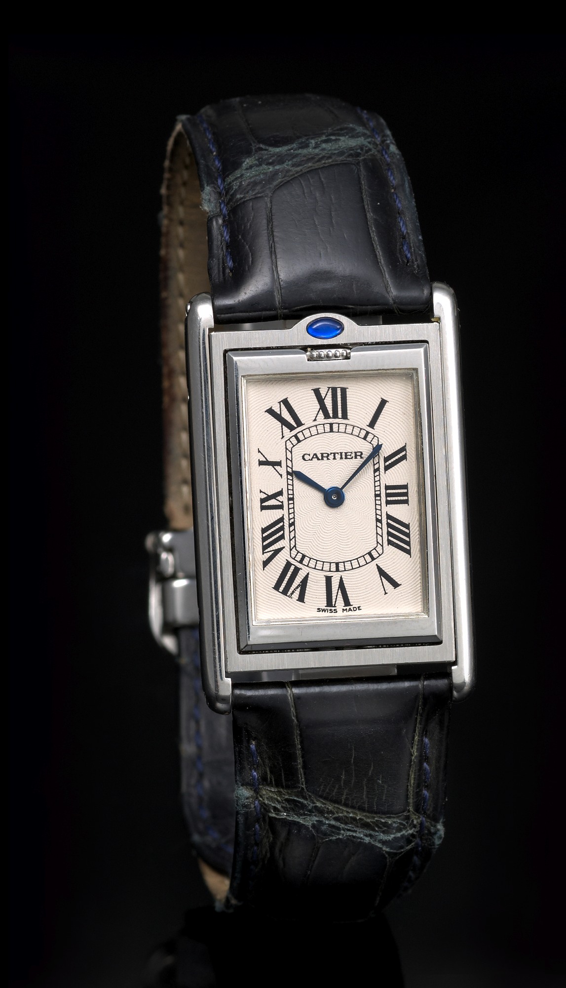 CARTIER REF. 2390 TANK BASCULANTE
MECHANIC, STEEL
Cartier, Paris, Reversible Basculante, case No. 68454 PB,
Ref. 2390. Made circa 2001.
Fine and unusual, rectangular, stainless steel wristwatch
with cabriolet pivoting system and a stainless steel Cartier
deployant clasp.