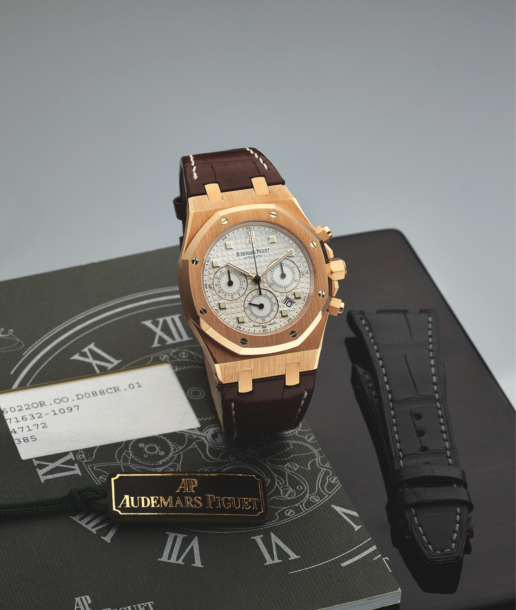AUDEMARS PIGUET REF. 26022 ROYAL OAK PINK GOLD
Audemars Piguet, Royal Oak Automatic, No. 1097, No.
572856, case No. F 71632, Ref. 260220R. Made in 2006,
sold June 2nd, 2007.
Fine, large, self-winding, water-resistant, 18K pink
gold wristwatch with round button chronograph,
registers, date and an 18K pink gold Audemars Piguet
deployant clasp. Accompanied by the original fitted
box, Certificate of Origin, instruction booklet, hang tag,
spare strap and a jeweler?s box.