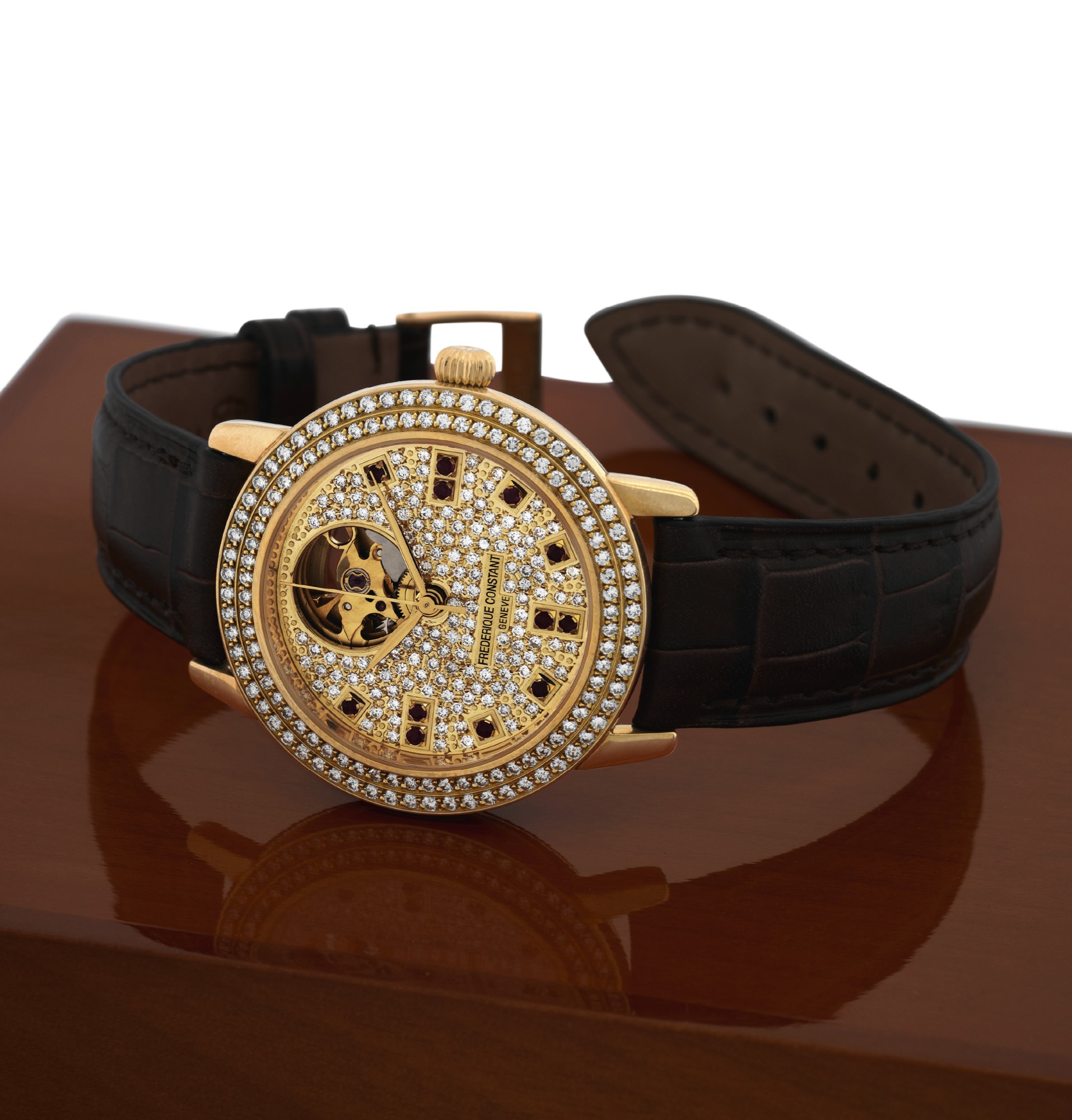 FREDERIQUE CONSTANT REF. FC 310 YELLOW
GOLD DIAMOND & RUBY ?ROYAL HEARTBEAT?
Frederique Constant, Genève, ?Royal Heartbeat,?
No. 15/100, Ref. FC-310 DR37. Made in a limited edition of
100 pieces circa 1998.
Fine, self-winding, water-resistant, 18K yellow gold wristwatch
with diamond-set bezel and pavé-diamond dial with
ruby hour markers with a total of 324 diamonds, a visible
escapement and an 18K yellow gold buckle. Accompanied by
a fitted wooden Frederique Constant box.