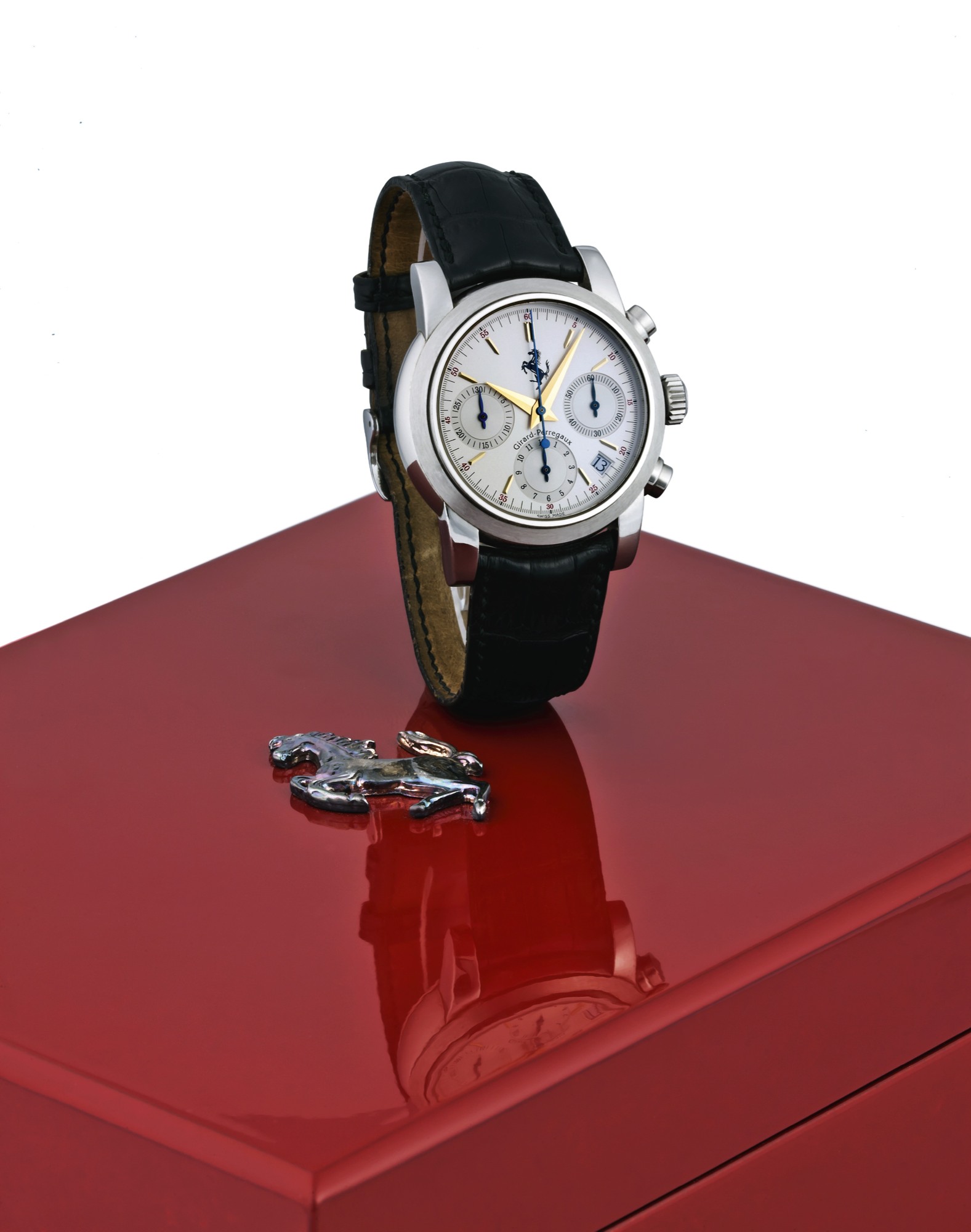 GIRARD-PERREGAUX REF. 8020 FERRARI
Girard-Perregaux, "Ferrari", No. 956, Ref. 8020. Sold on July
28th, 1996.
Fine, self-winding, water-resistant, stainless steel wristwatch
with round button chronograph, registers, date and a
stainless steel Girard-Perregaux buckle. Accompanied by the
international warranty, booklets and original fitted box.