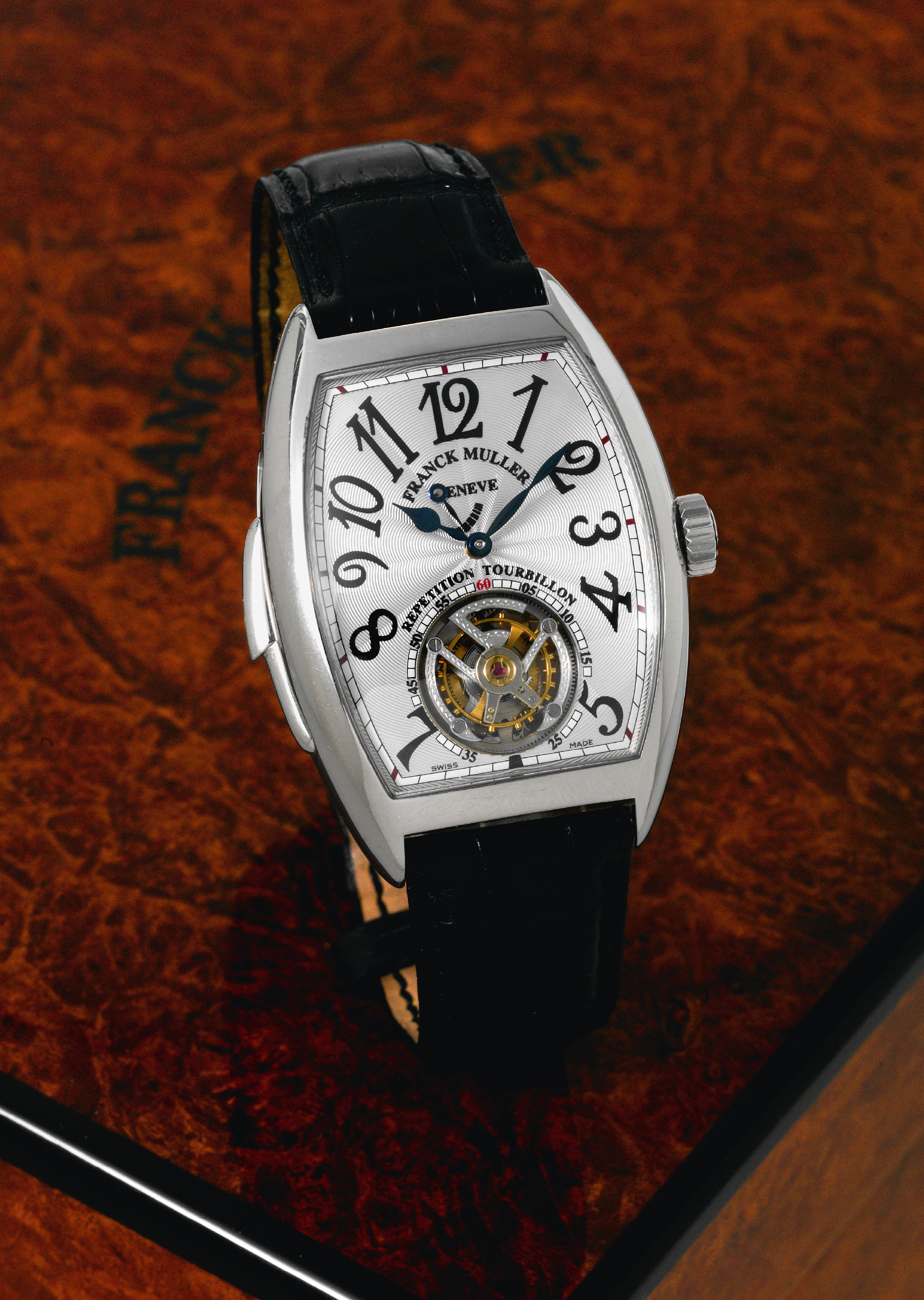 Platinum Minute-Repeater Tourbillon
Franck Muller, Geneve, "Cintrée Curvex Répétition
Tourbillon" No. 09, Ref. 7880 RM T. Made circa 2007.
Very fine and very rare, large, curved tonneau-shaped,
platinum wristwatch with visible one-minute flying tourbillon
regulator, minute repeater, retrograde repeater indicator and
an 18K white gold Franck Muller buckle. Accompanied by a
fitted box and certificate.