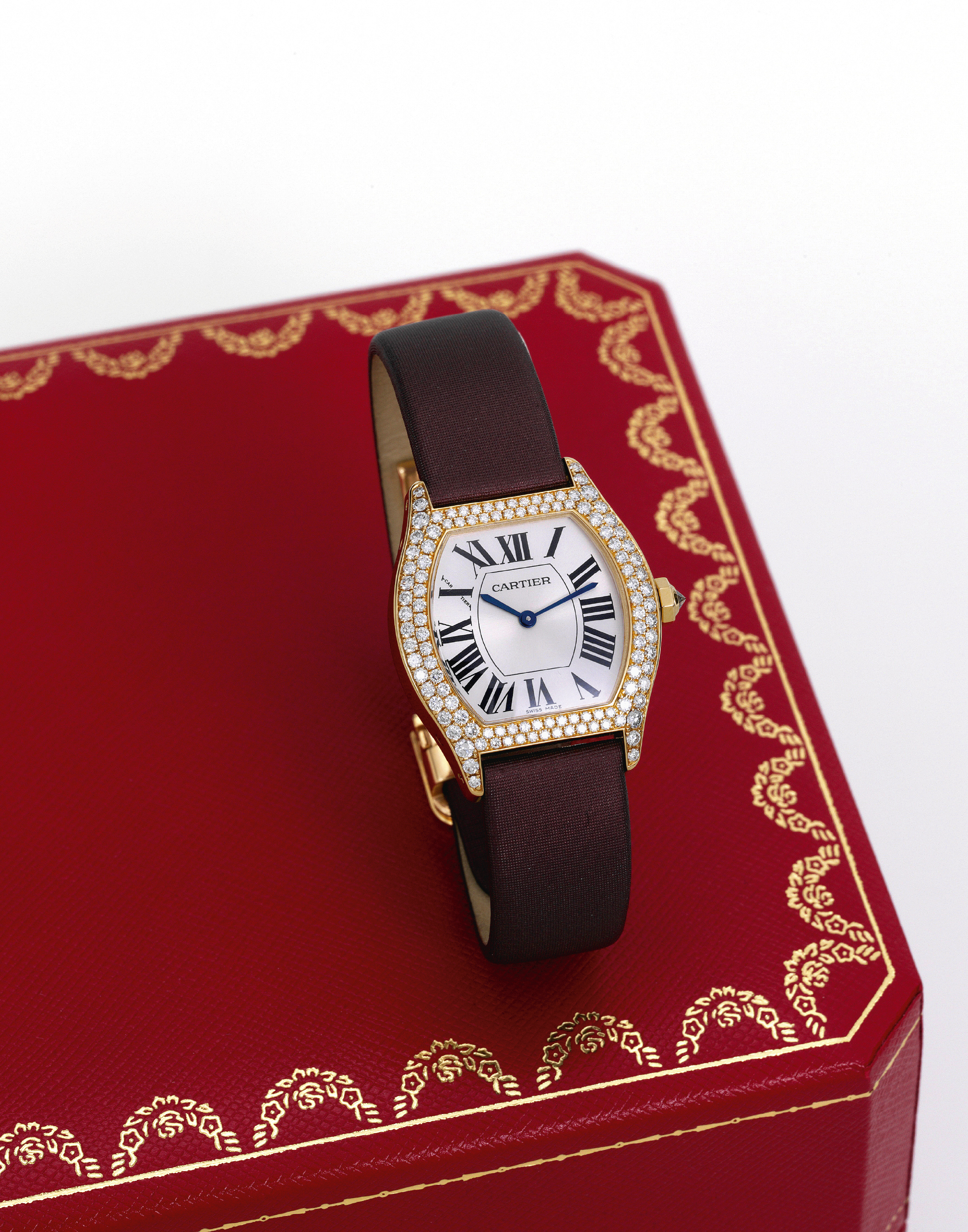 Diamond Tortue
Cartier, Collection Privée Cartier ?Tortue,? No. 16340 CE, Ref. 2643. Made circa 2005.
Fine, tonneau-shaped, water-resistant, 18K yellow gold and diamond-set wristwatch with an 18K yellow gold Cartier
deployant clasp. Accompanied by a Cartier fitted box, certificate and booklet.