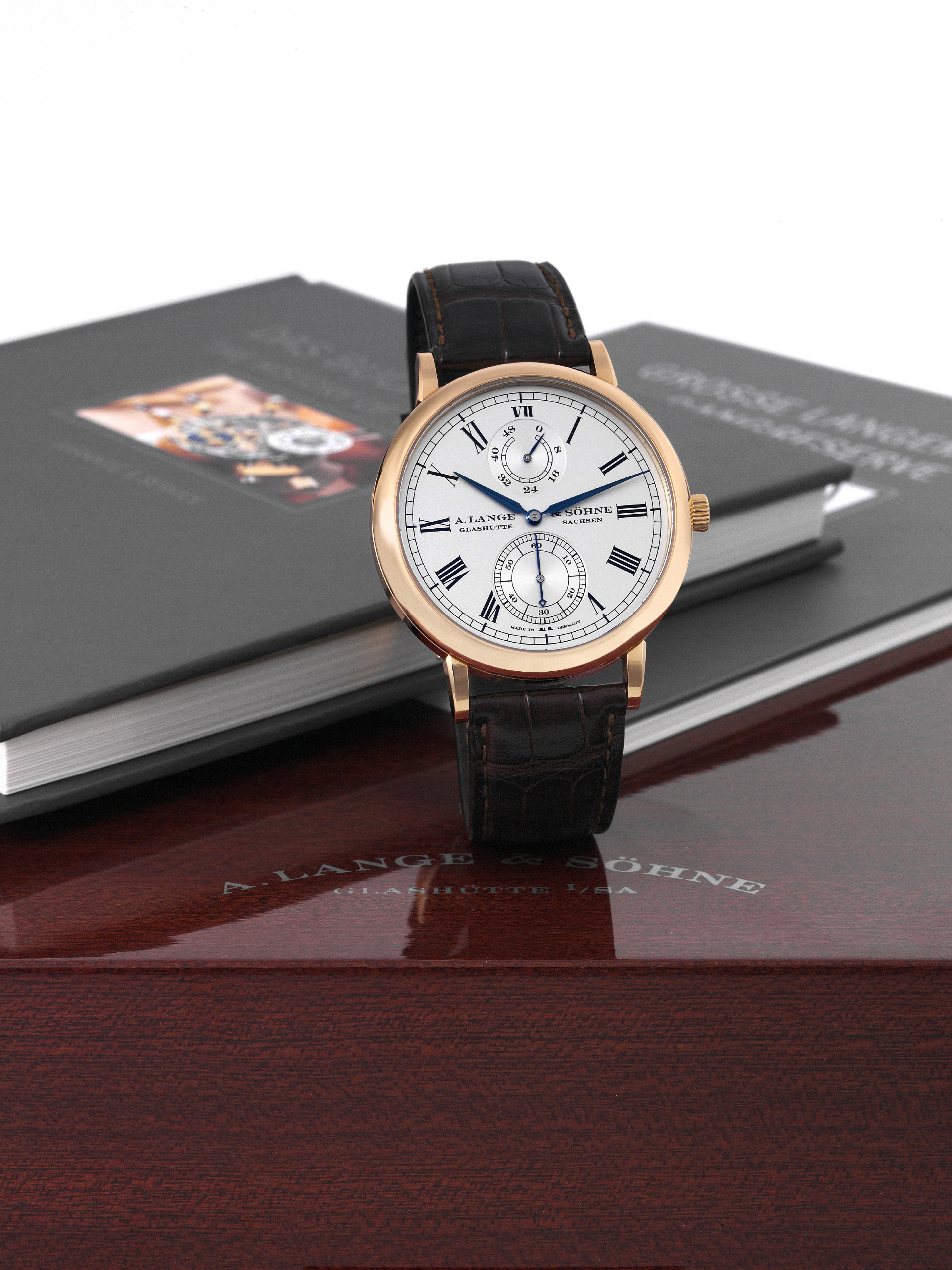 For Wempe
A. Lange & Söhne, Glashütte i. Sa., "Grosse Langematik,
Sax-O-Mat, Gangreserve," No. 11/25, movement No. 50014,
case No. 160211, Ref. 304.047. Made in a limited edition of
25 pieces exclusively to commemorate the 25th Anniversary
of Wempe NY in 2005.
Very fine and very rare, self-winding, 18K pink gold
wristwatch with zero-reset function, power-reserve
indication and an 18K pink gold A. Lange & Söhne buckle.
Accompanied by the original fitted box, guarantee, certificate
and i