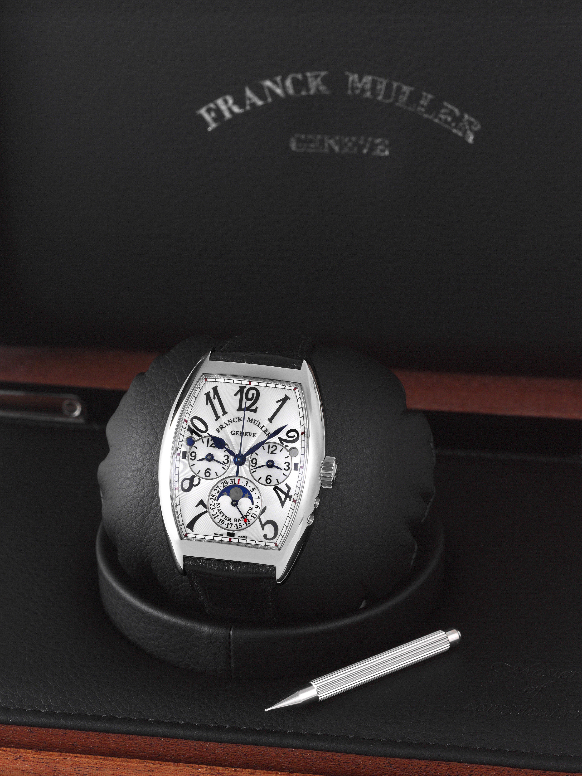 Franck Muller Cintree Curvex Master Banker Lunar Date
Franck Muller, Genève, "Cintrée Curvex master banker lunar date", no. 326, ref. 7880 mb l dt. made circa 2006.
fine, three time zone, curved tonneau-shaped, self-winding, water-resistant, center-seconds, stainless steel wristwatch with
one crown for adjusting all three dials, two day and night indicators, date, moon phase and a stainless steel franck muller
buckle. Accompanied by a franck muller fitted box and instructions.