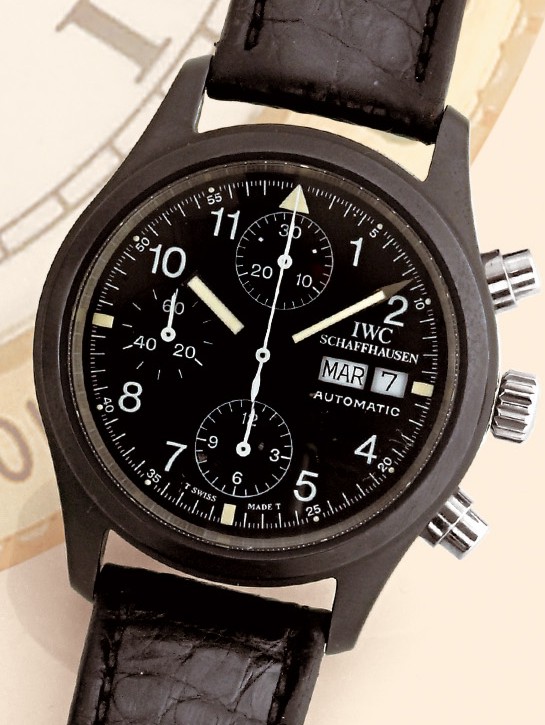 "Der Fliegerchronograph"
International Watch Co., Schaffhausen, "Der
Fliegerchronograph - Automatic". Made in the
late 1990s.
Fine, large, self-winding, water-resistant to 50 meters, stainless
steel and PVD-coated gentleman's wristwatch with
round button chronograph, registers, day and date and a
stainless steel IWC buckle.