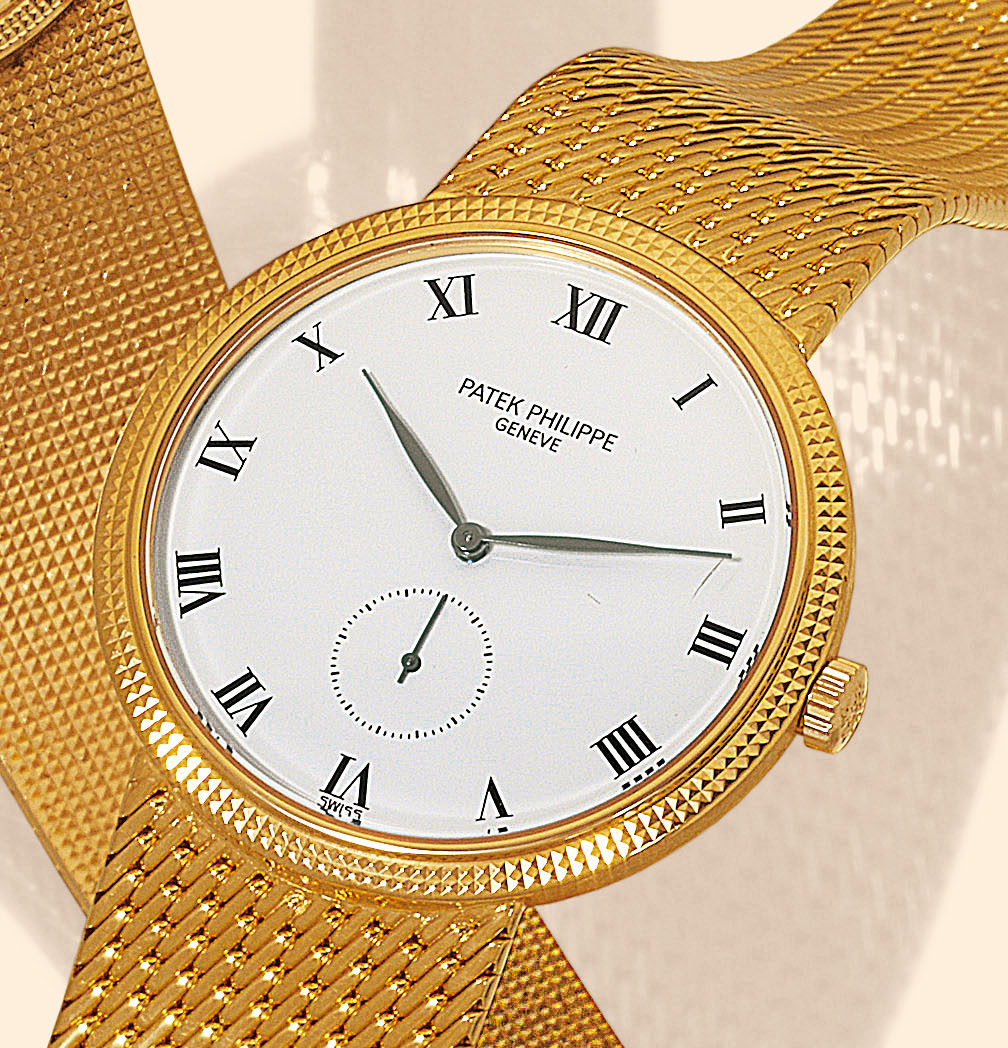Yellow Gold Ref. 3919/5, ?Clous de Paris?
Patek Philippe & Cie, Genève, No. 1814910, case No. 2850866, Ref. 3919/5. Made circa 1985.
Fine and elegant, flat, 18K yellow gold gentleman?s wristwatch with linen-textured 18K yellow gold Patek
Philippe bracelet.