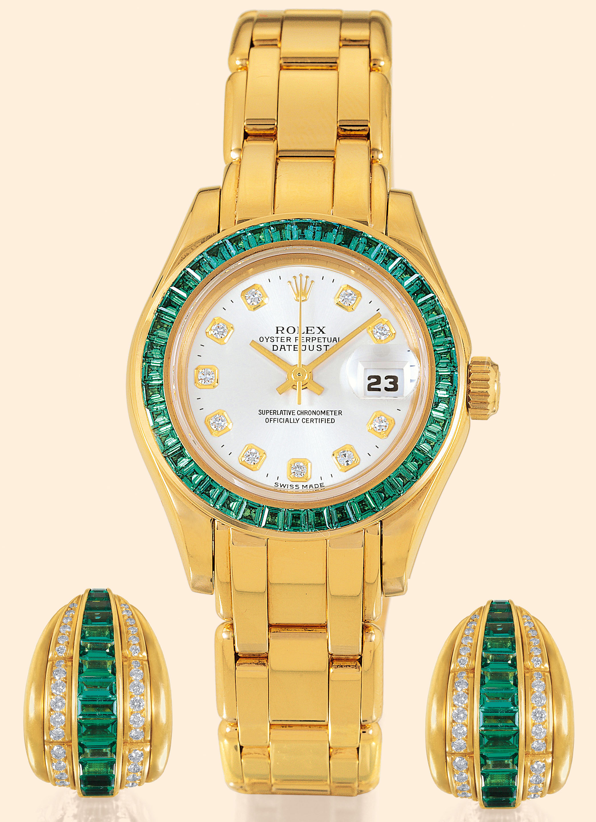 Ref. 69308 Emerald and Diamond
?DateJust? Suite
Rolex, ?Oyster Perpetual, DateJust,
Superlative Chronometer Officially
Certified?, Ref. 69308. Made circa 2000.
Very fine and rare, tonneau-shaped, center-seconds, selfwinding,
water-resistant, 18K yellow gold, diamond and
emerald-set lady?s wristwatch with date and an 18K yellow
gold Oyster bracelet. Accompanied by emerald and diamond
ear clips, a fitted box and certificate (now void).
