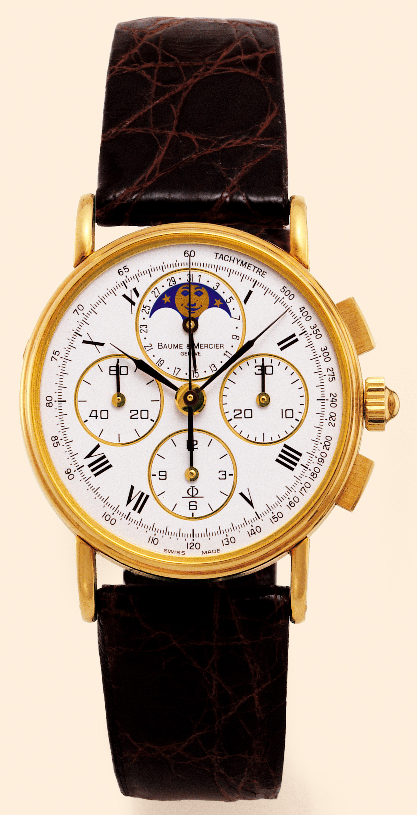 Baume & Mercier, Genève.  Made in the 1990s. Fine, astronomic, mid-size, 18K yellow gold gentleman's wristwatch with square button chronograph, registers, tachometer, date and moon phases. Accompanied by a fitted box and certificate.