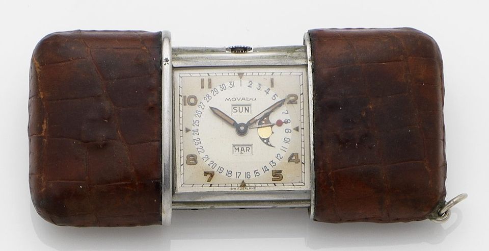 Movado. A base metal triple calendar manual wind travel watch with moon phasesCase No.1247523M, Circa 1940's