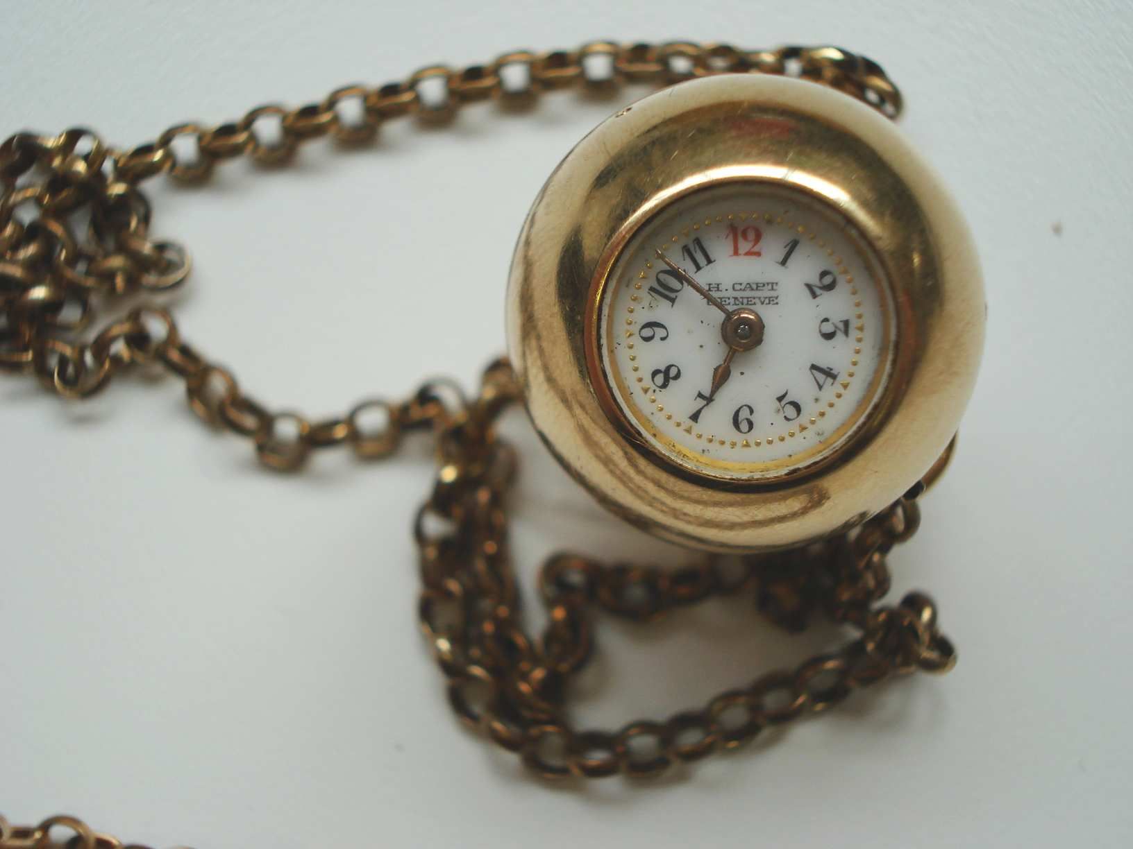 Swiss. An 18ct gold spherical fob watch