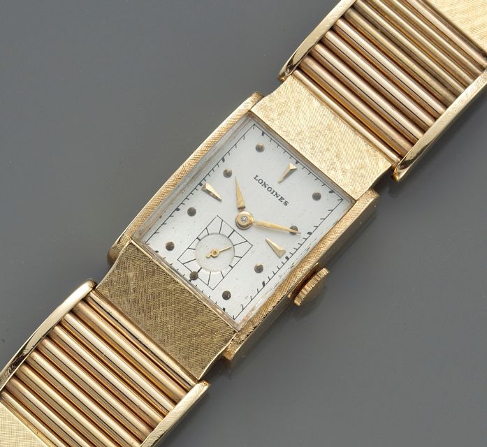 Longines. A fourteen karat gold rectangular bracelet watch1940s