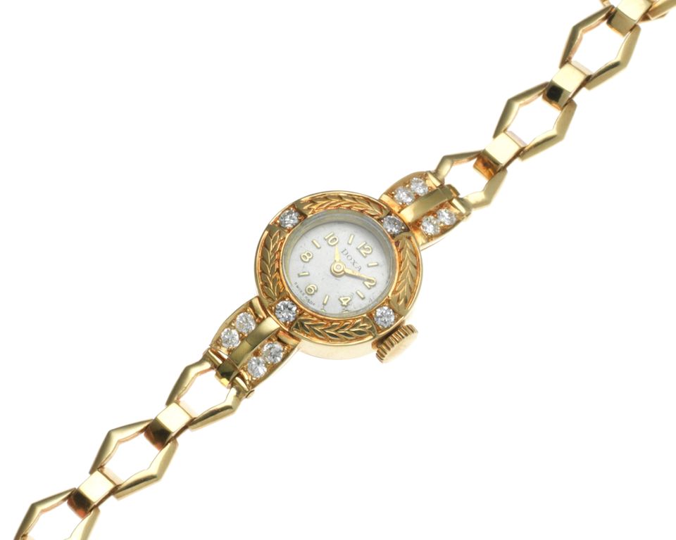 Doxa. A lady's 18K gold and diamond set manual wind bracelet watch