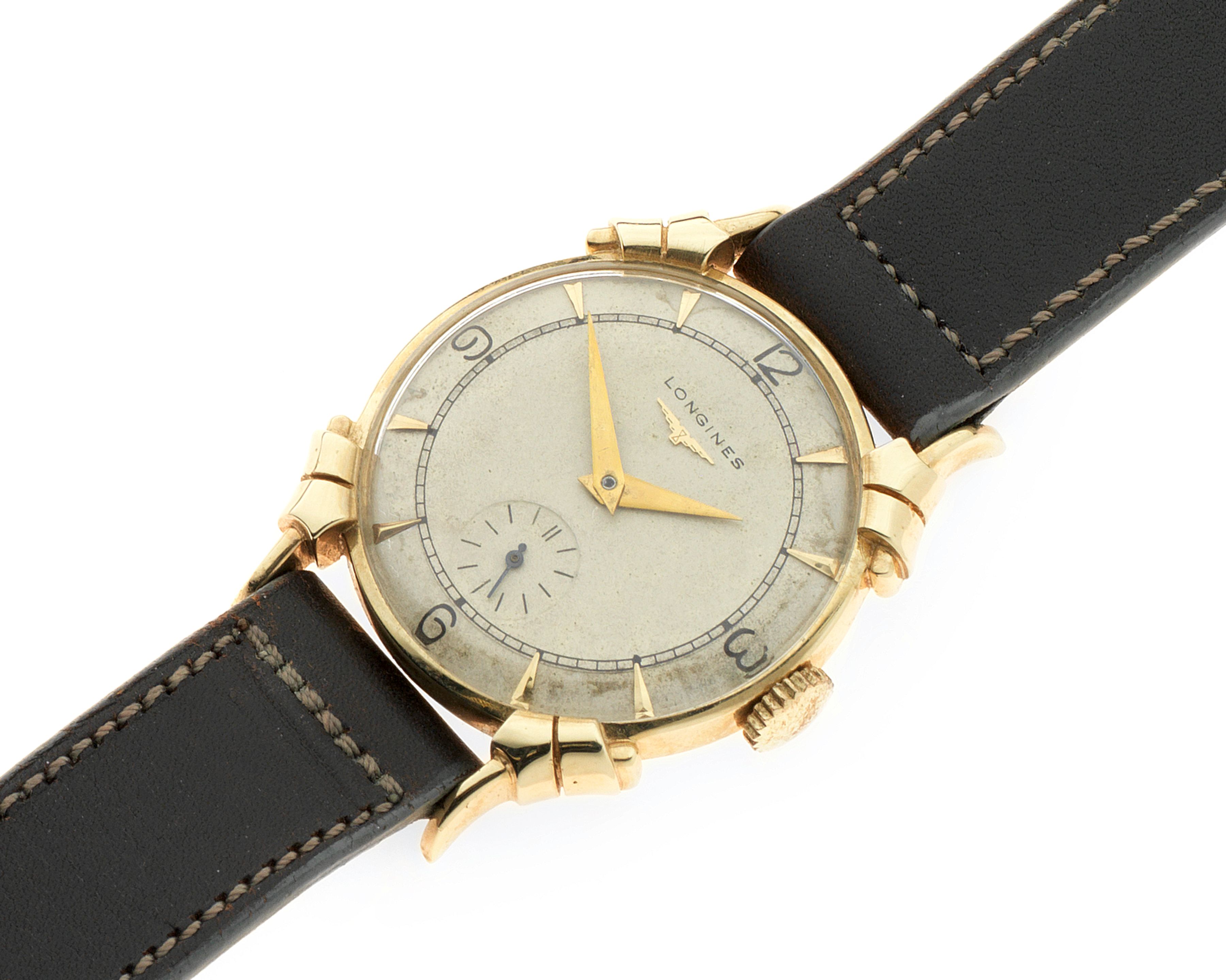 Longines. A 14K gold manual wind wristwatch with fancy lugs