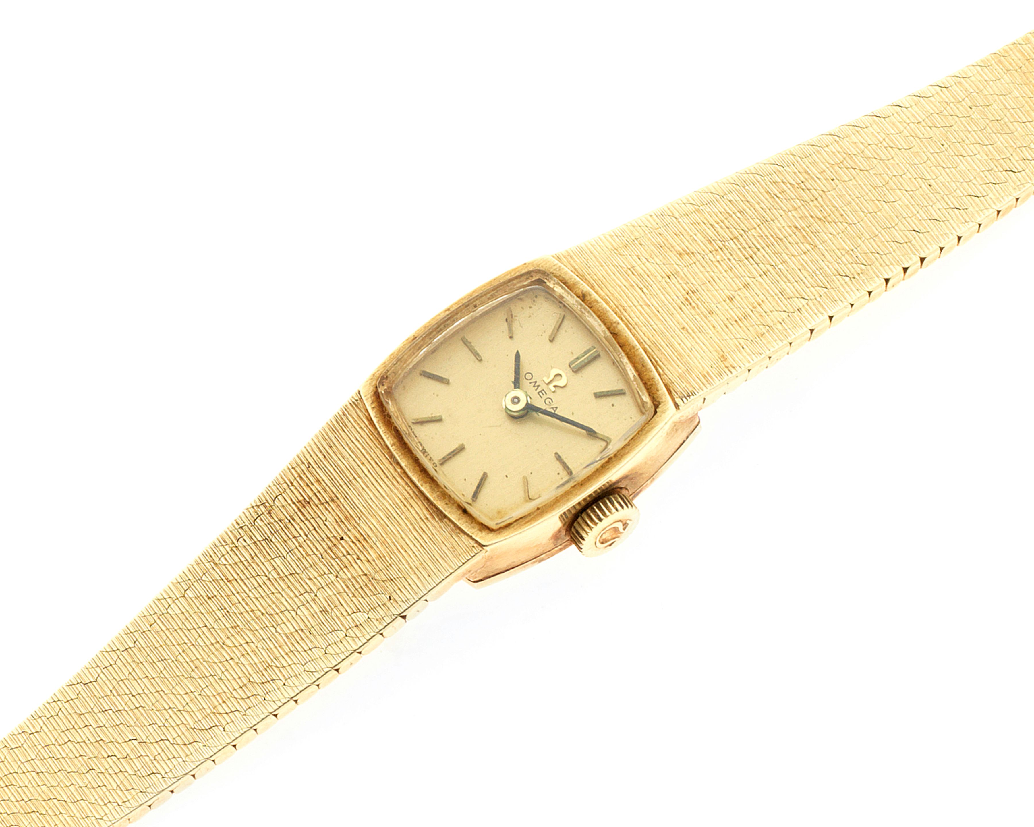 Omega. A lady's 14K gold manual wind square bracelet watch