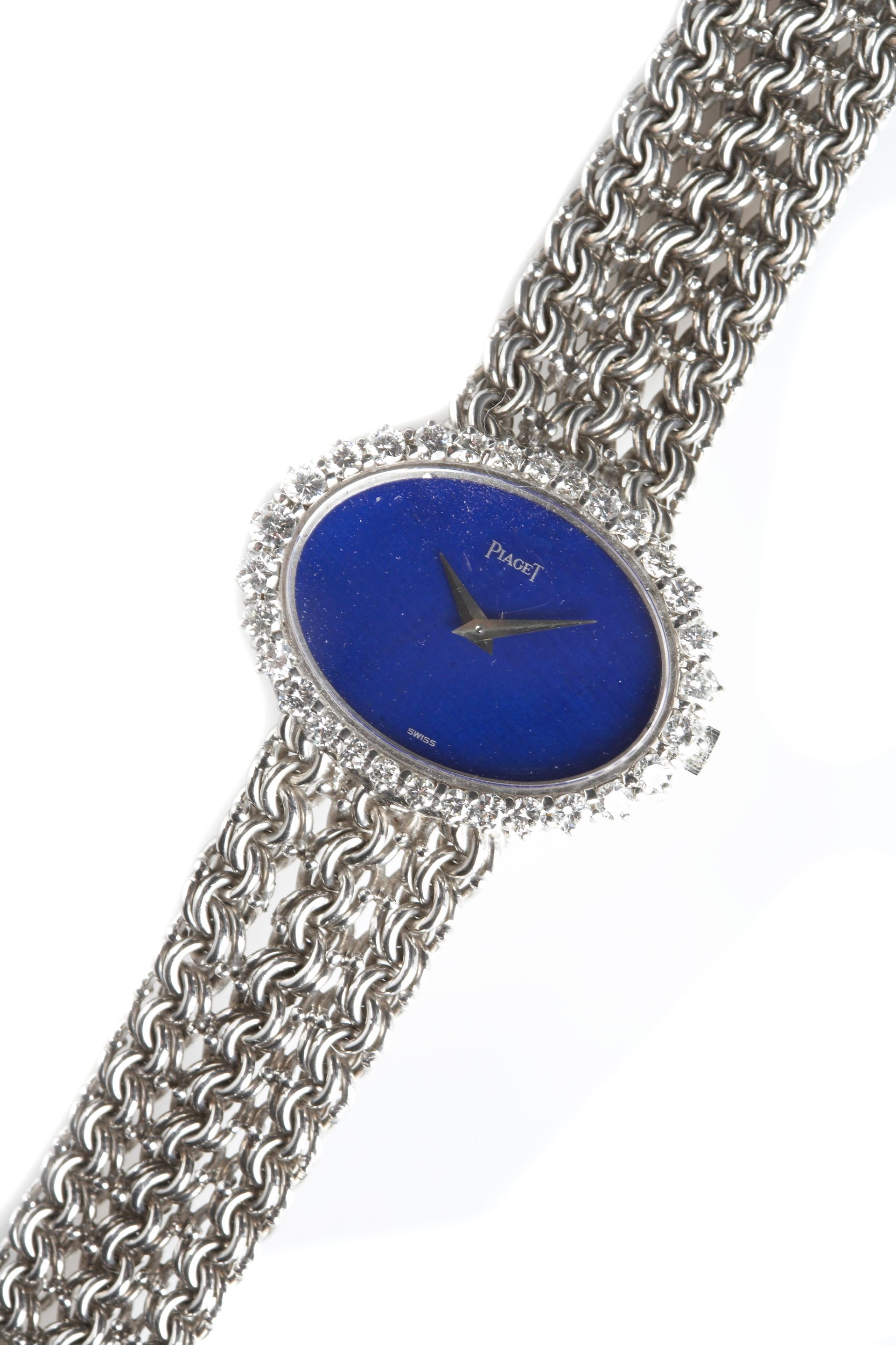 Piaget. A ladies 18k white gold oval cased bracelet watch with diamond set bezel and lapis lazuli dial1970s