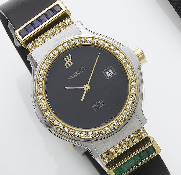 Hublot. A lady's stainless steel and gold diamond, emerald and sapphire set calendar wristwatch1980's