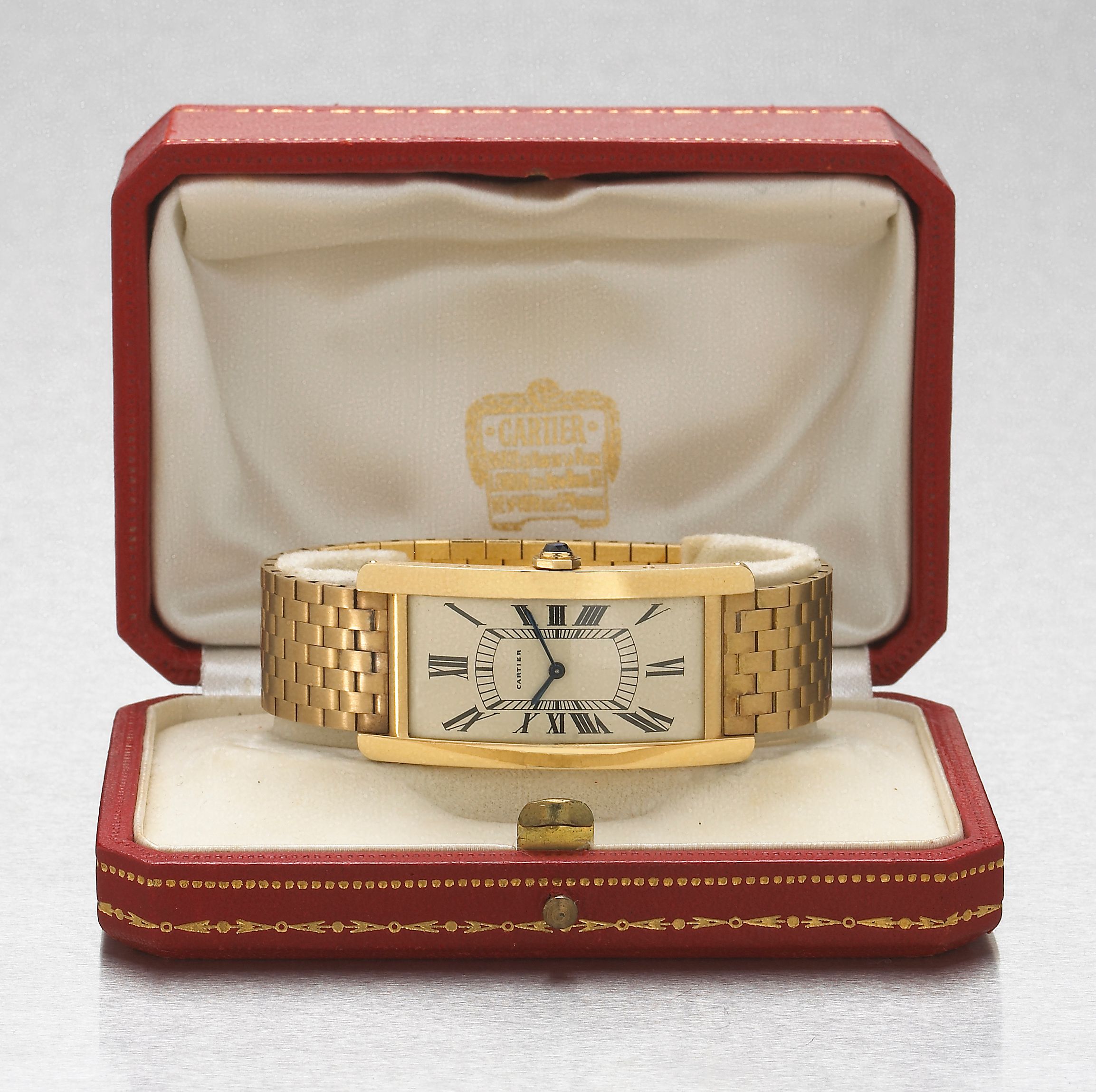 Cartier, Paris. A very fine and rare 18k gold large curved rectangular wristwatch on original fitted 18k gold braceletTank Américain, Case No.40759, Movement No.486234, late ...