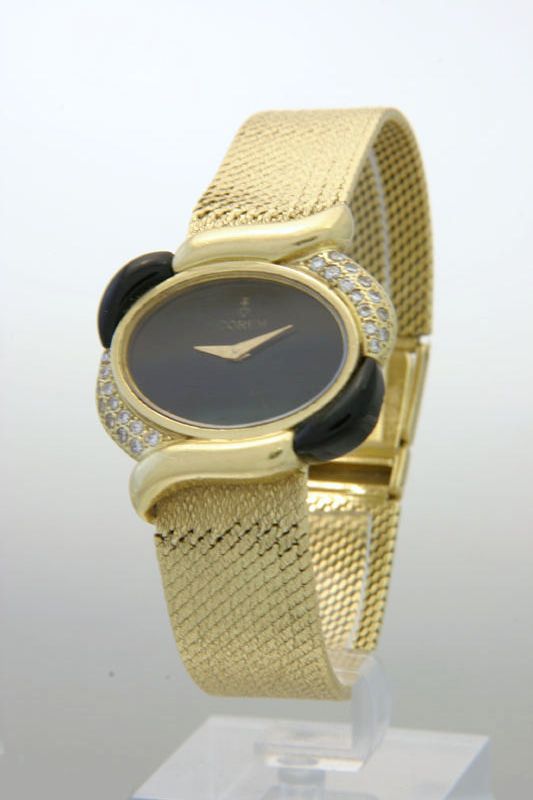 Corum. A lady's 1970s 18ct gold, diamond and onyx set bracelet watch