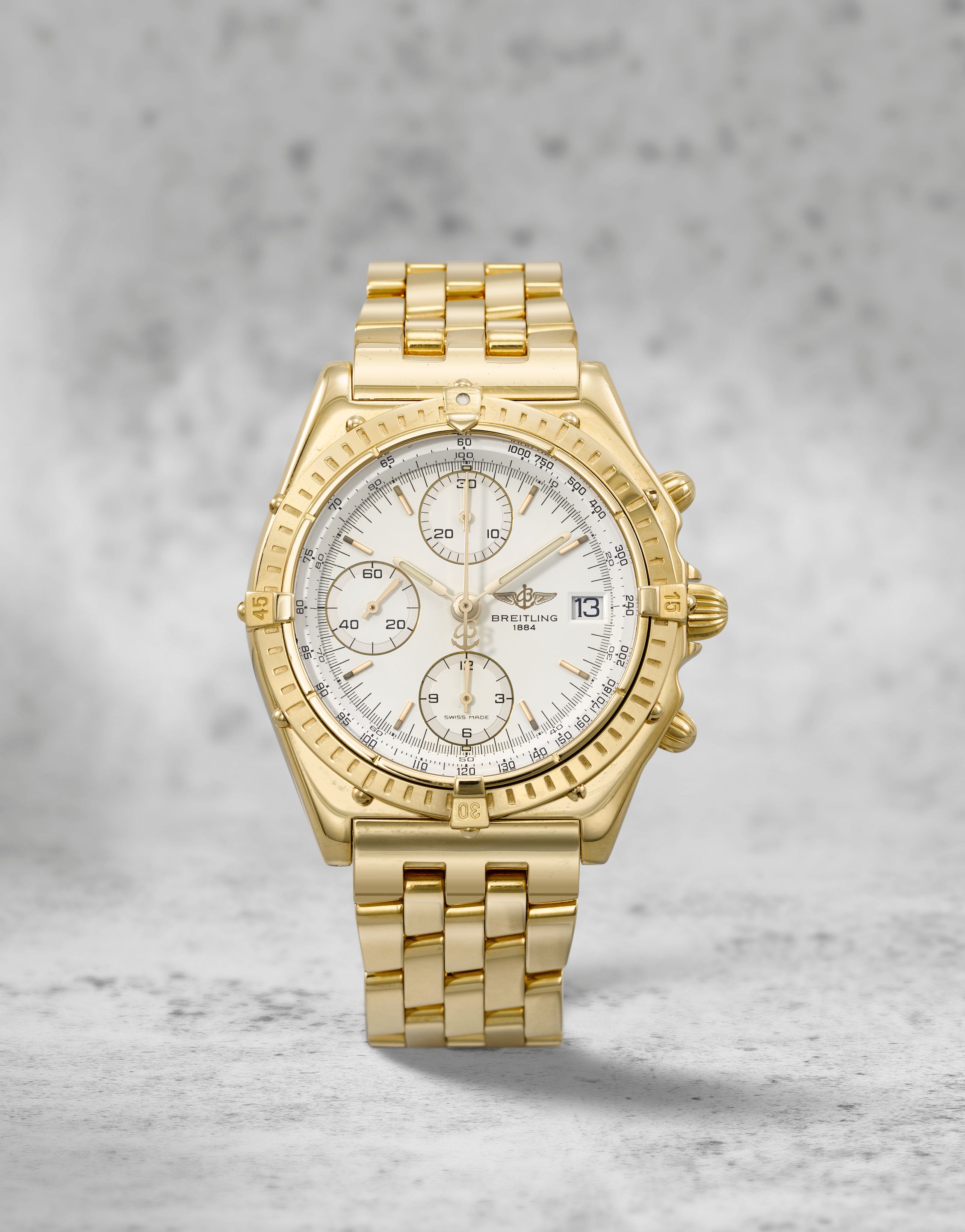 Breitling. An 18K gold automatic calendar chronograph bracelet watch Chronomat, Ref: K13047X, Purchased 9th December 1997