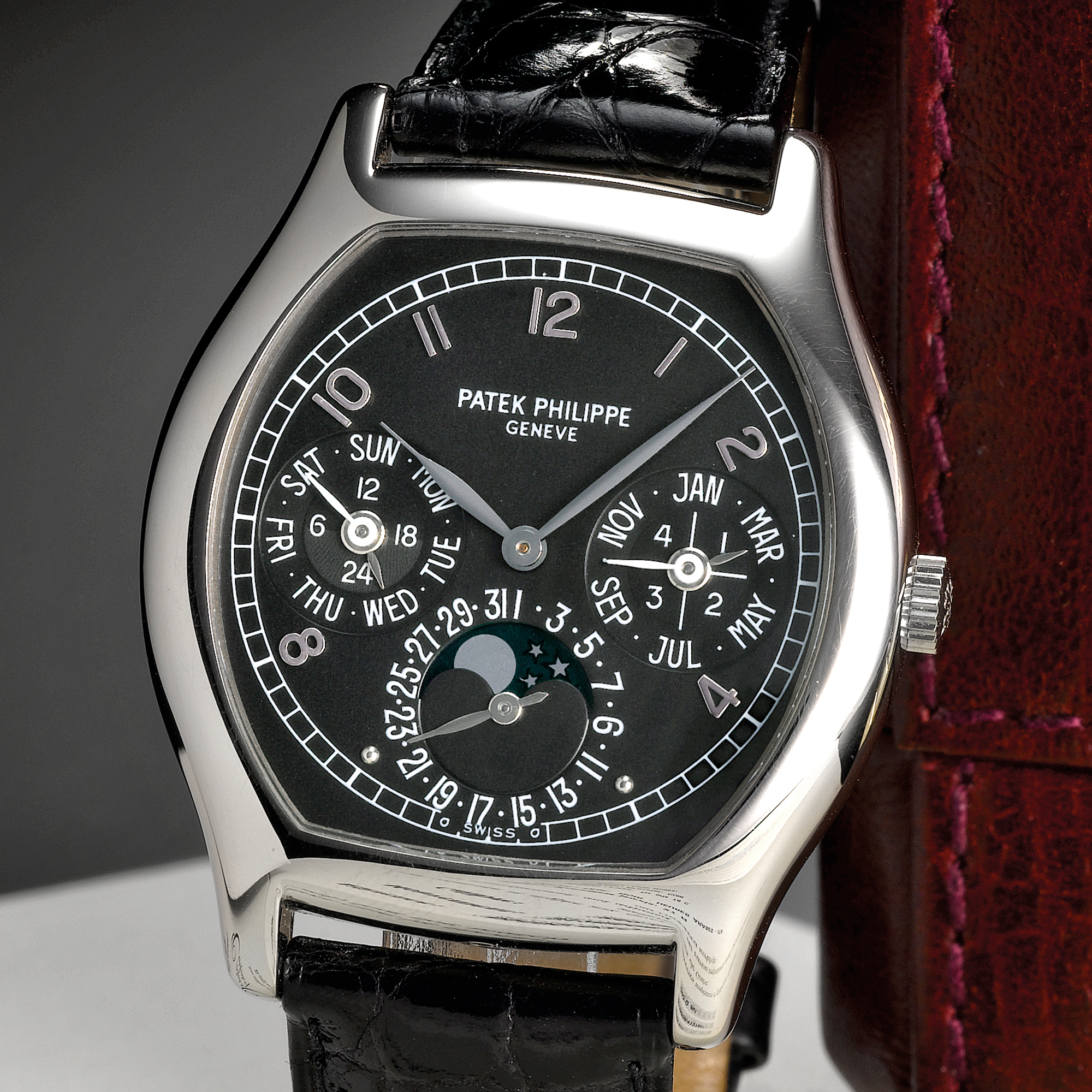 Patek Philippe, A FINE AND RARE WHITE GOLD TONNEAU FORM AUTOMATIC PERPETUAL CALENDAR WRISTWATCH WITH MOON-PHASES AND LEAP YEAR INDICATION CIRCA 2003 REF 5040G 2ND SERIES MVT 3125808  CASE 4127847 