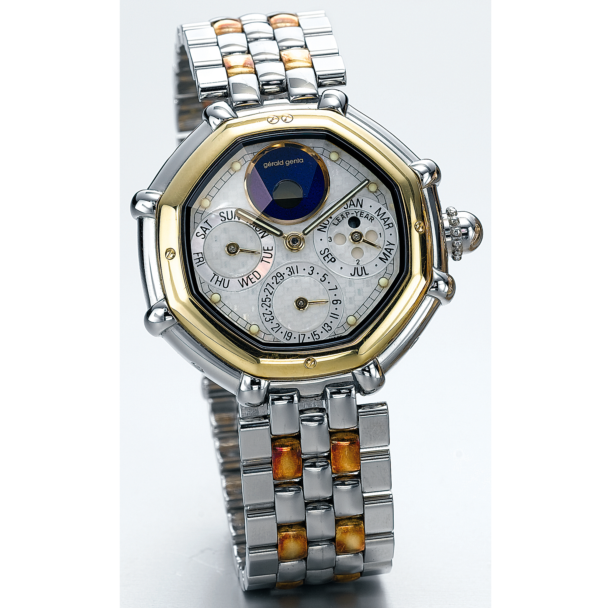 GÉRALD GENTA, A STAINLESS STEEL AND GOLD AUTOMATIC PERPETUAL CALENDAR BRACELET WATCH WITH MOTHER-OF-PEARL DIAL AND MOON-PHASESCIRCA 1990 SUCCESS