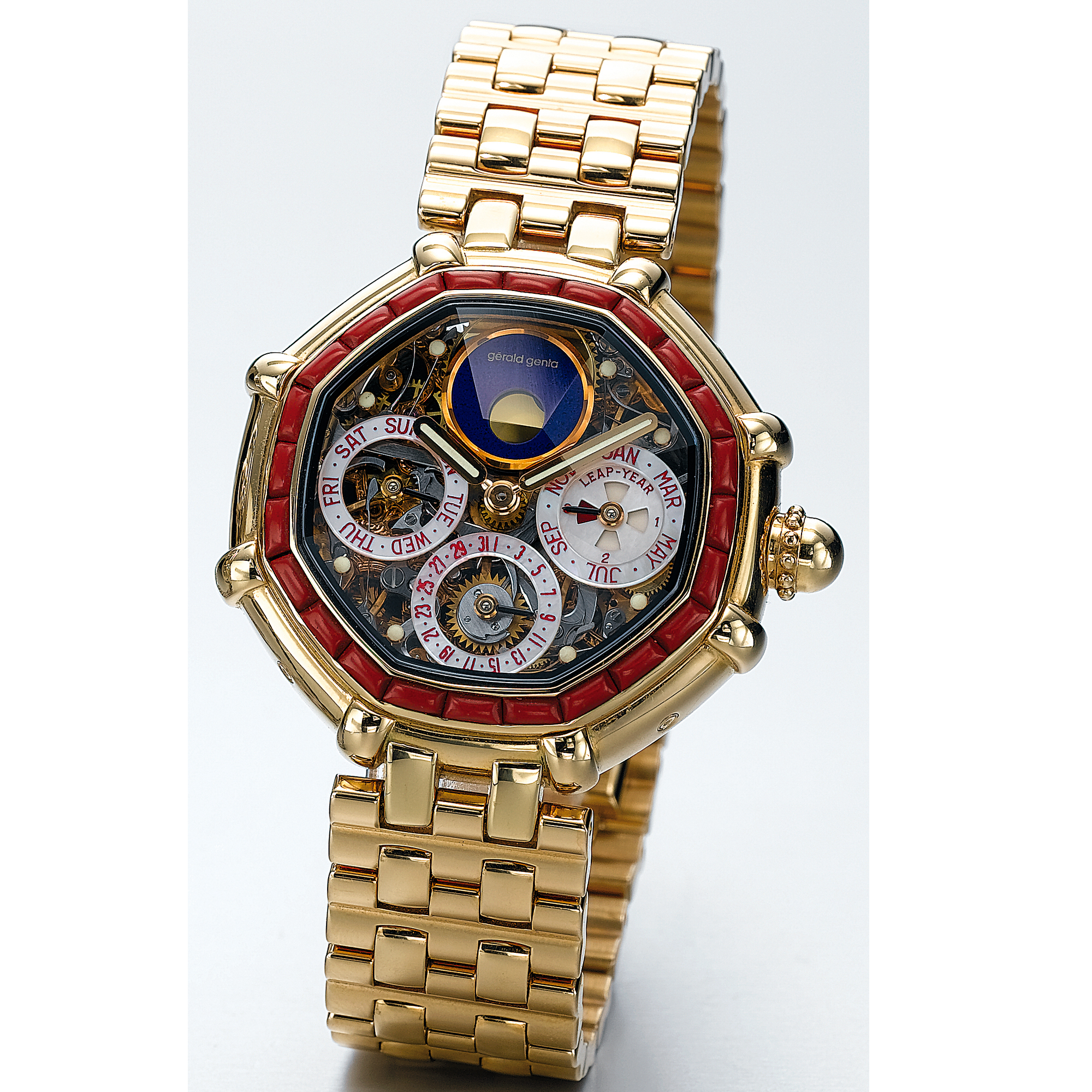 GÉRALD GENTA, A GOLD AND CORAL AUTOMATIC OCTANGONAL PERPETUAL CALENDAR BRACELET WATCH WITH SKELETONISED DIAL AND MOON-PHASESCIRCA 1990 NO 64696