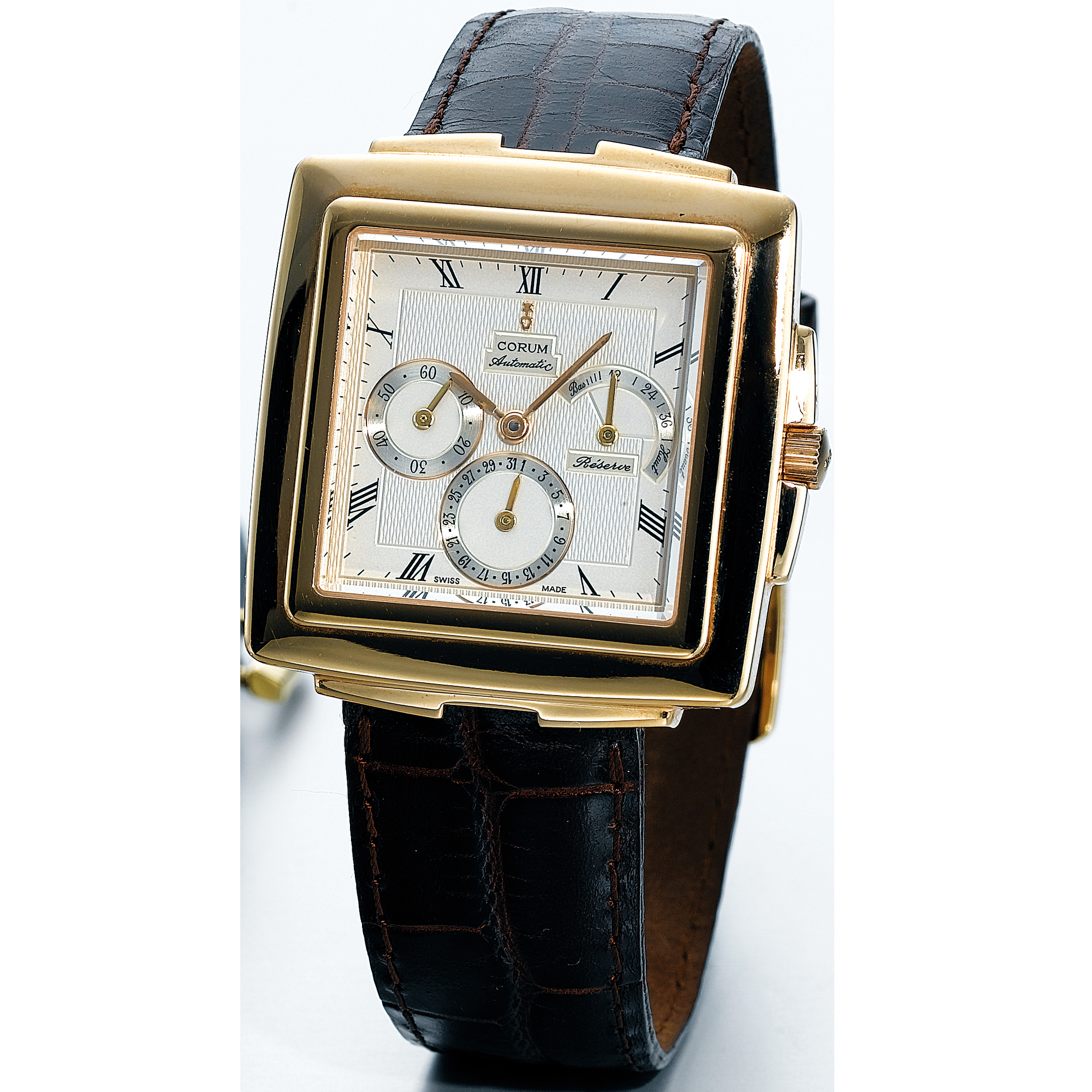 CORUM, A GOLD RECTANGULAR AUTOMATIC WRISTWATCH WITH DATE AND POWER RESERVECIRCA 1998 QUADRATUS NO 8