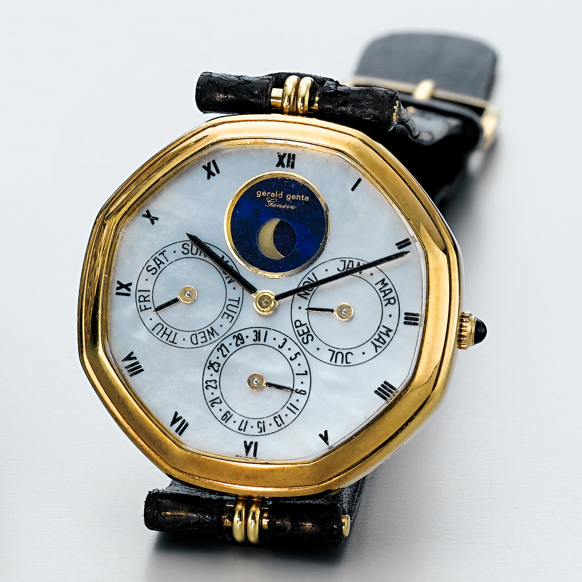 GÉRALD GENTA, A GOLD AUTOMATIC OCTAGONAL TRIPLE CALENDAR WRISTWATCH WITH MOON-PHASES AND MOTHER-OF-PEARL DIALCIRCA 1990