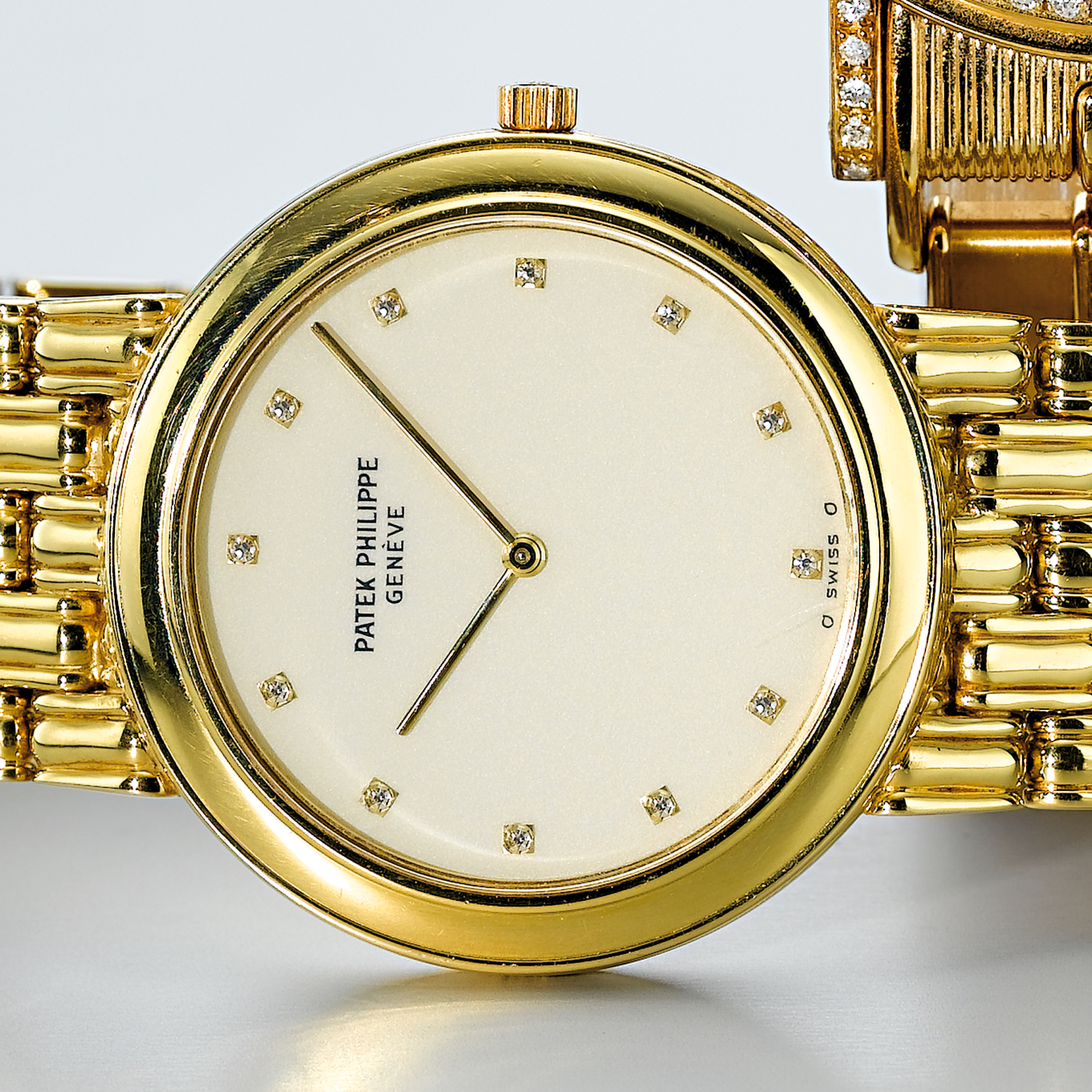 PATEK PHILIPPE, A GOLD AND DIAMOND SET BRACELET WATCH CIRCA 1990