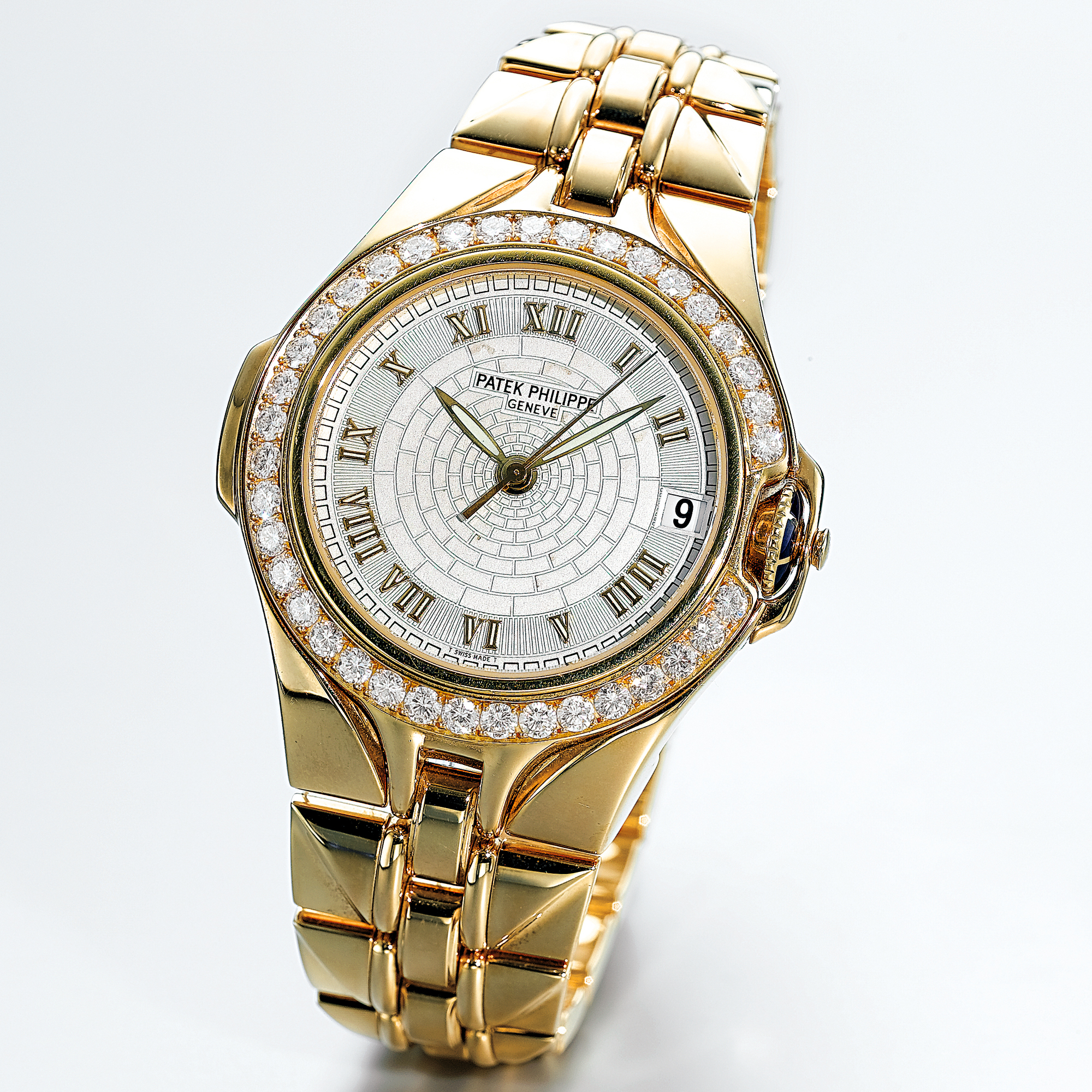 PATEK PHILIPPE, A RARE GOLD AND DIAMOND SET AUTOMATIC CENTRE SECONDS BRACELET WATCH WITH DATECIRCA 1995 REF 5091/1J SCULPTURE