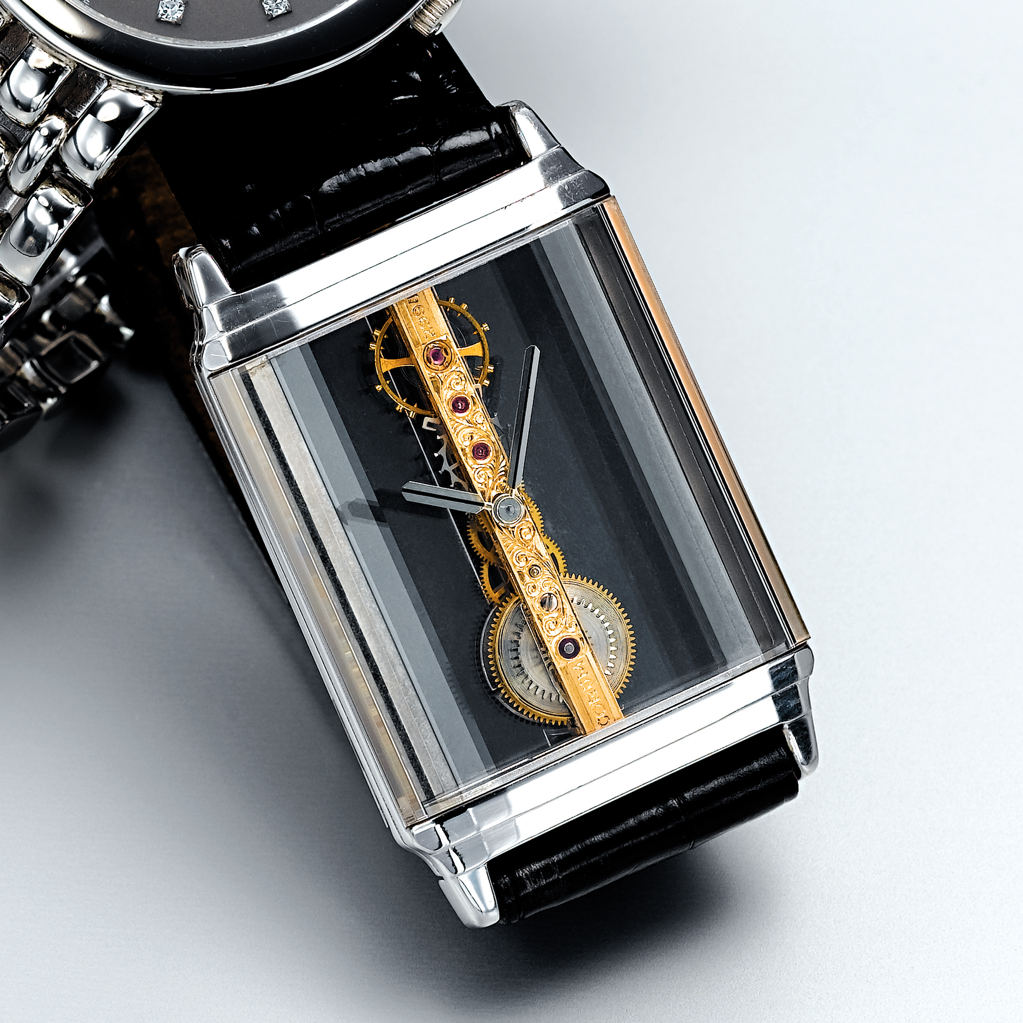 CORUM, A WHITE GOLD RECTANGULAR SKELETONISED LINEAR MOVEMENT WRISTWATCH CIRCA 1995 GOLDEN BRIDGE