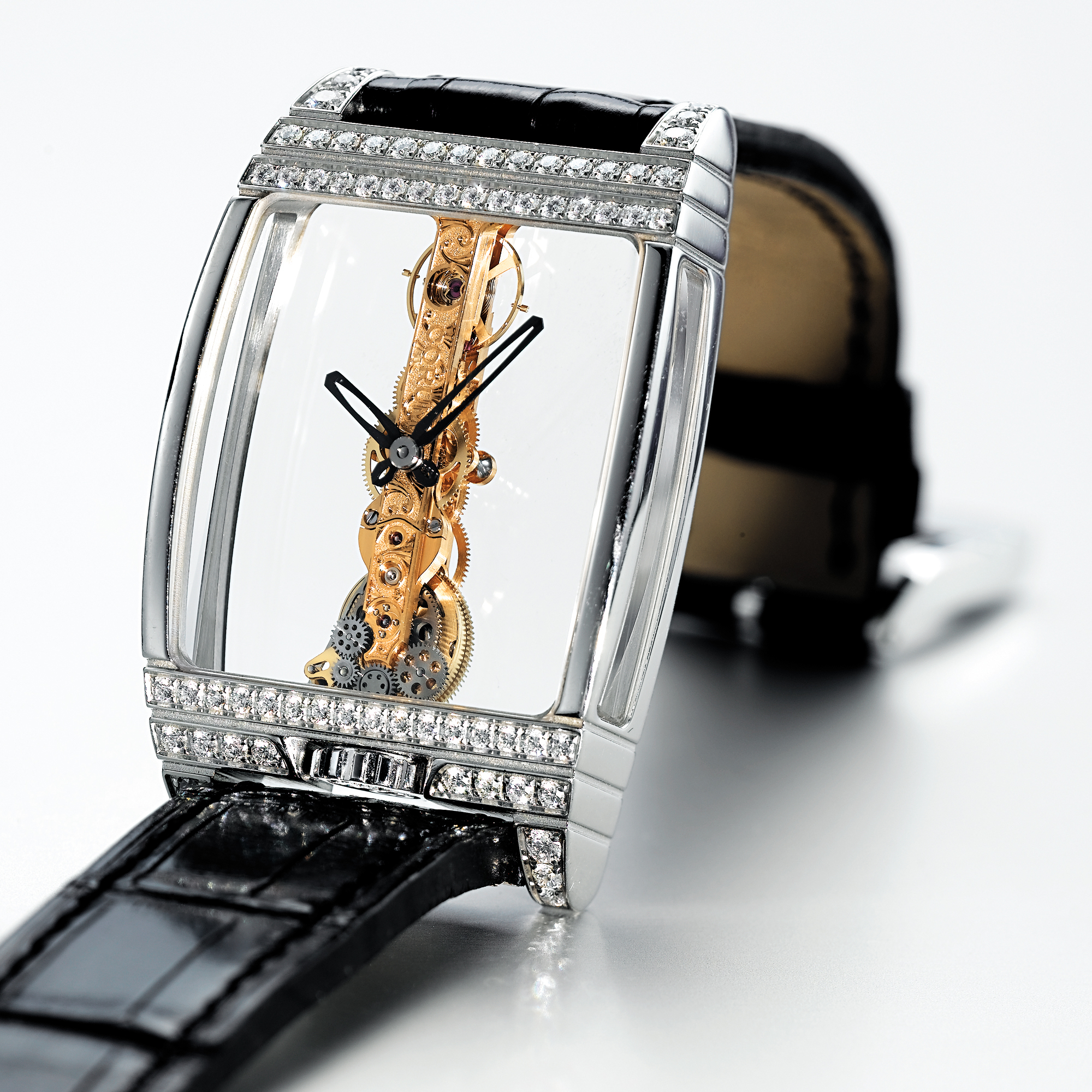 CORUM, A FINE LARGE PLATINUM AND DIAMOND SKELETONISED TONNEAU WRISTWATCHCIRCA 2005 GOLDEN BRIDGE 50TH ANNIVERSARY MODEL