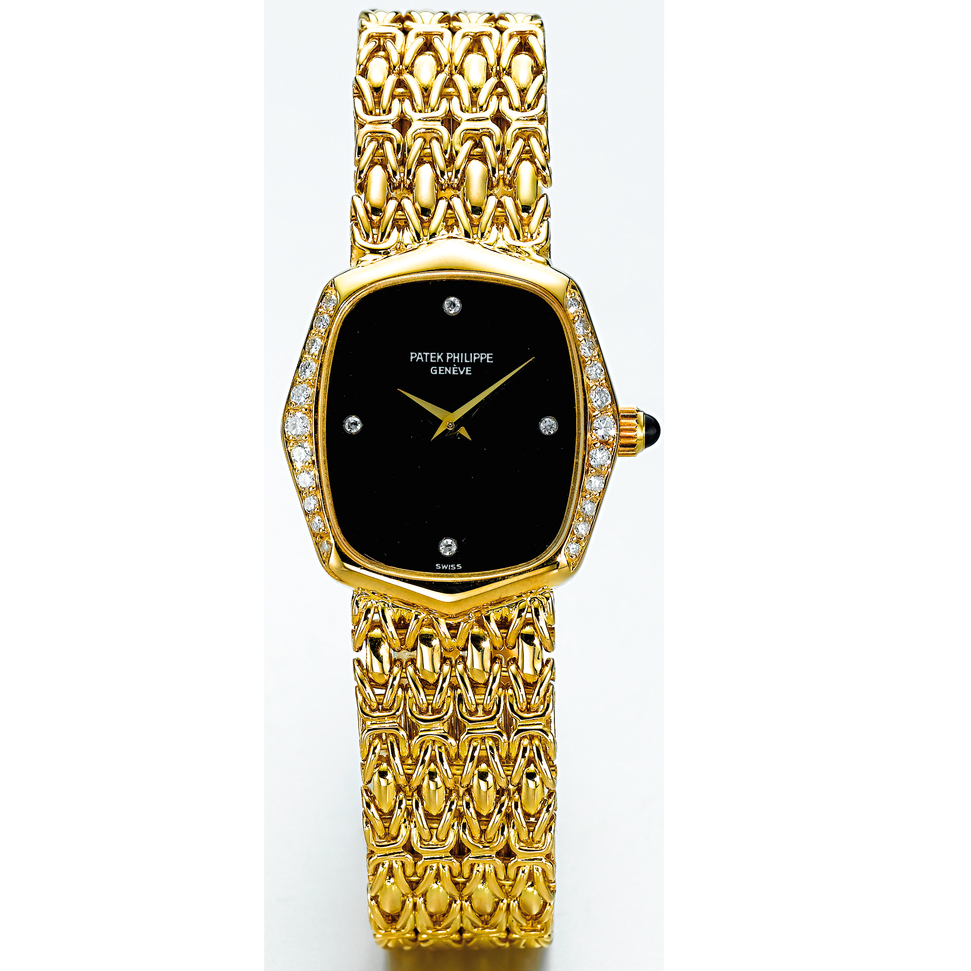 PATEK PHILIPPE, A LADY'S GOLD AND DIAMOND SET CUSHION FORM BRACELET WATCH WITH ONYX DIALCIRCA 1990