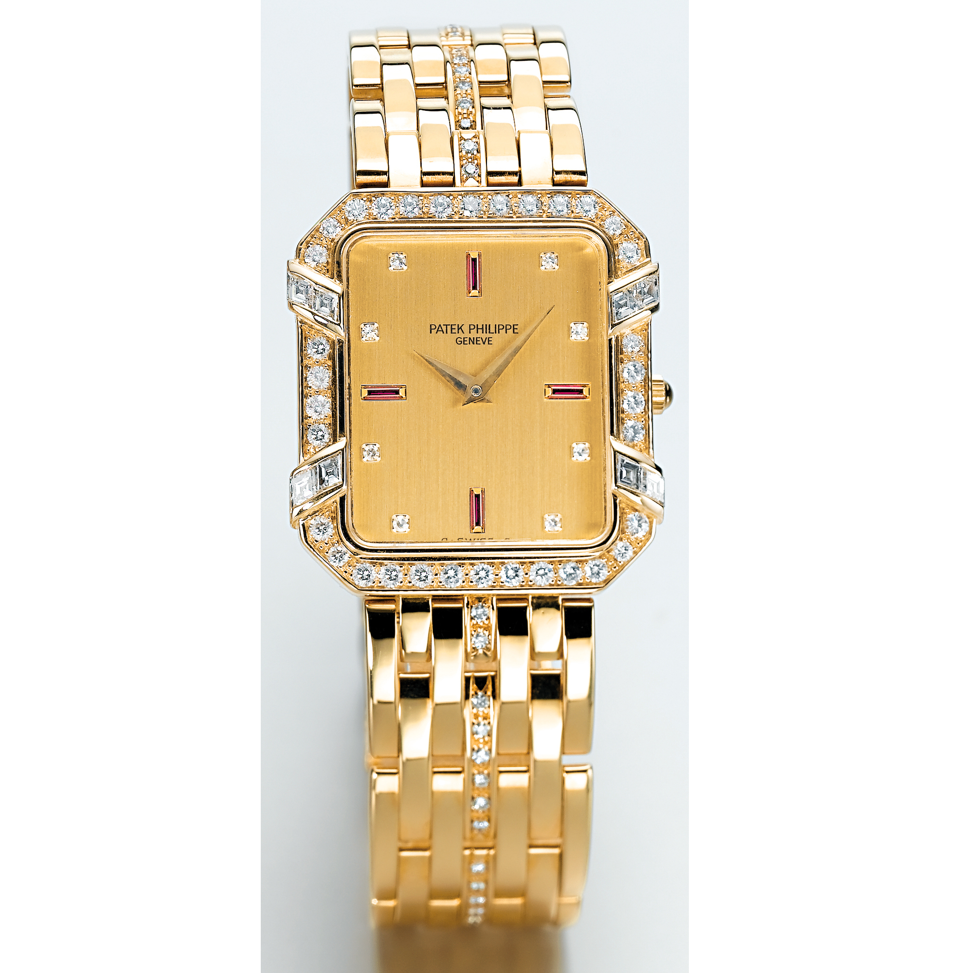 PATEK PHILIPPE, A GOLD, DIAMOND AND RUBY SET RECTANGULAR BRACELET WATCH CIRCA 1990 REF 3833 MVT NO 1549218 CASE NO 2855888