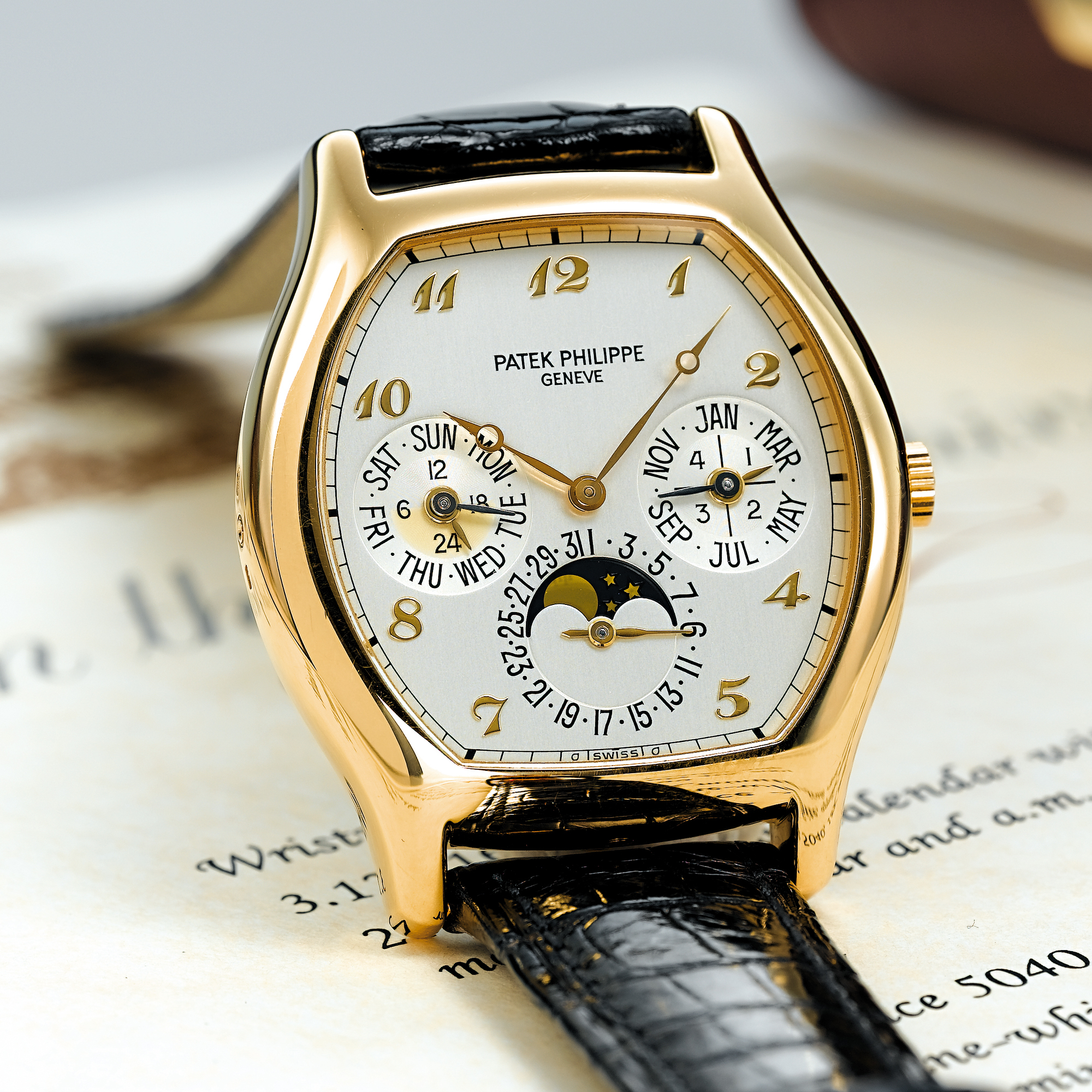 PATEK PHILIPPE, A FINE GOLD TONNEAU AUTOMATIC PERPETUAL CALENDAR WRISTWATCH WITH MOON-PHASESCIRCA 1995 REF 5040J MVT 3125163 CASE 2981687
