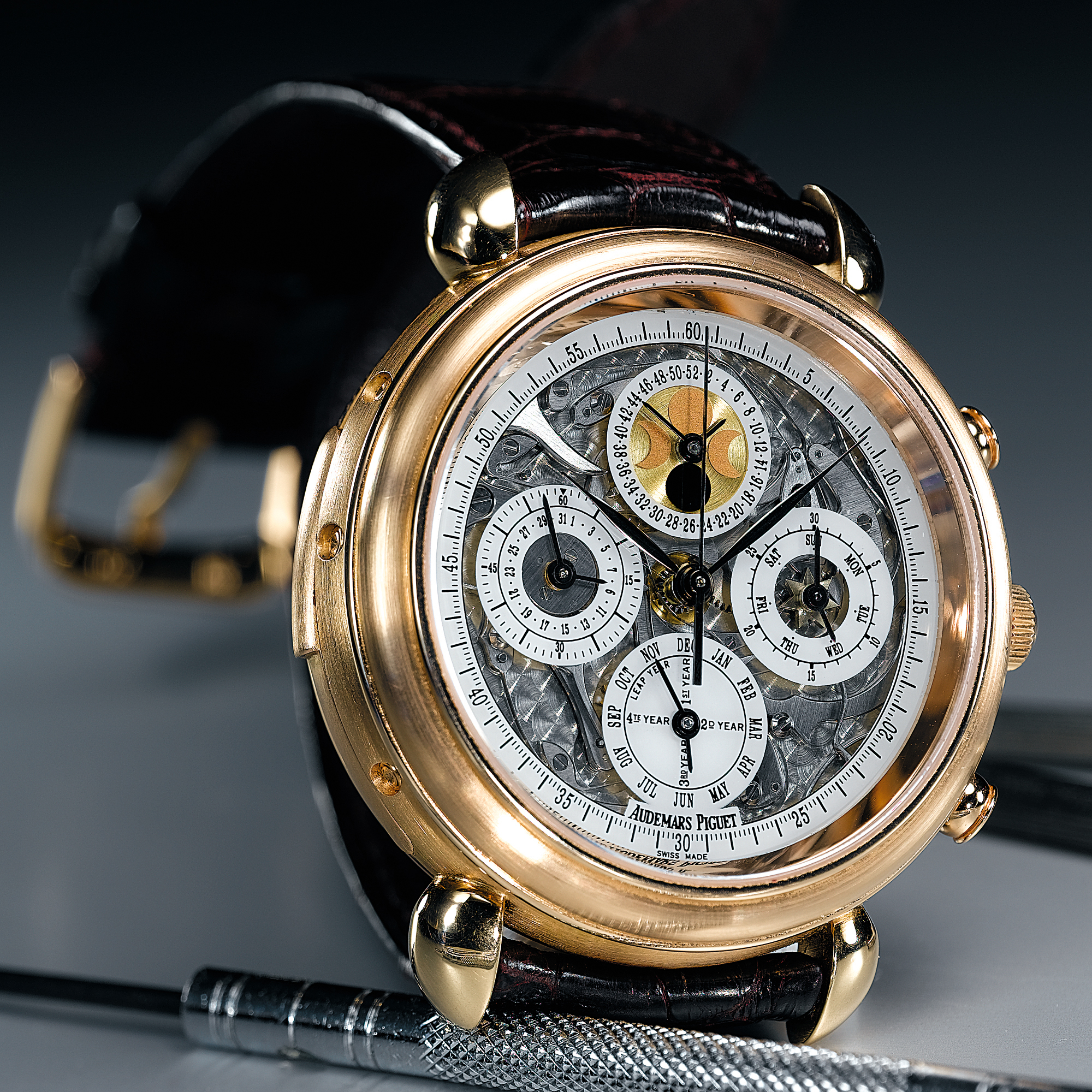 AUDEMARS PIGUET, A FINE AND RARE PINK GOLD AUTOMATIC SKELETONISED MINUTE REPEATING PERPETUAL CALENDAR CHRONOGRAPH WRISTWATCH WITH MOON-PHASES AND 52-WEEK INDICATIONCIRCA 1995 TRIPLE COMPLICATION AUTOMATIQUE NO 1
